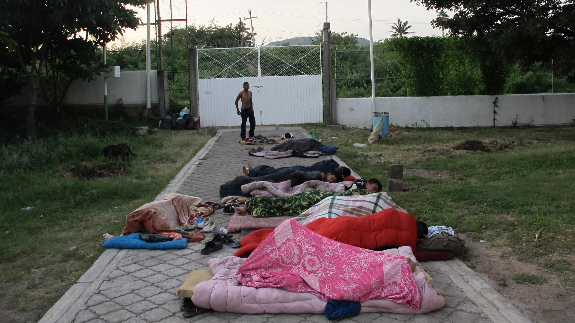 Migrants sleep on the ground at dawn at the Hermanos en el Camino shelter in Ixtepec, Oaxaca. The buildings here are too damaged by the recent earthquakes to enter. 