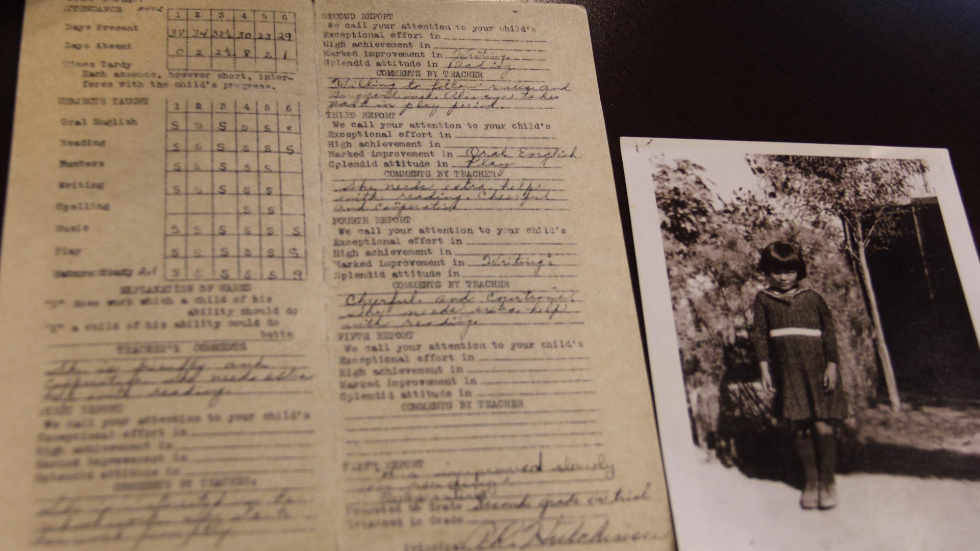 Image of old report card with black and white photo of young girl