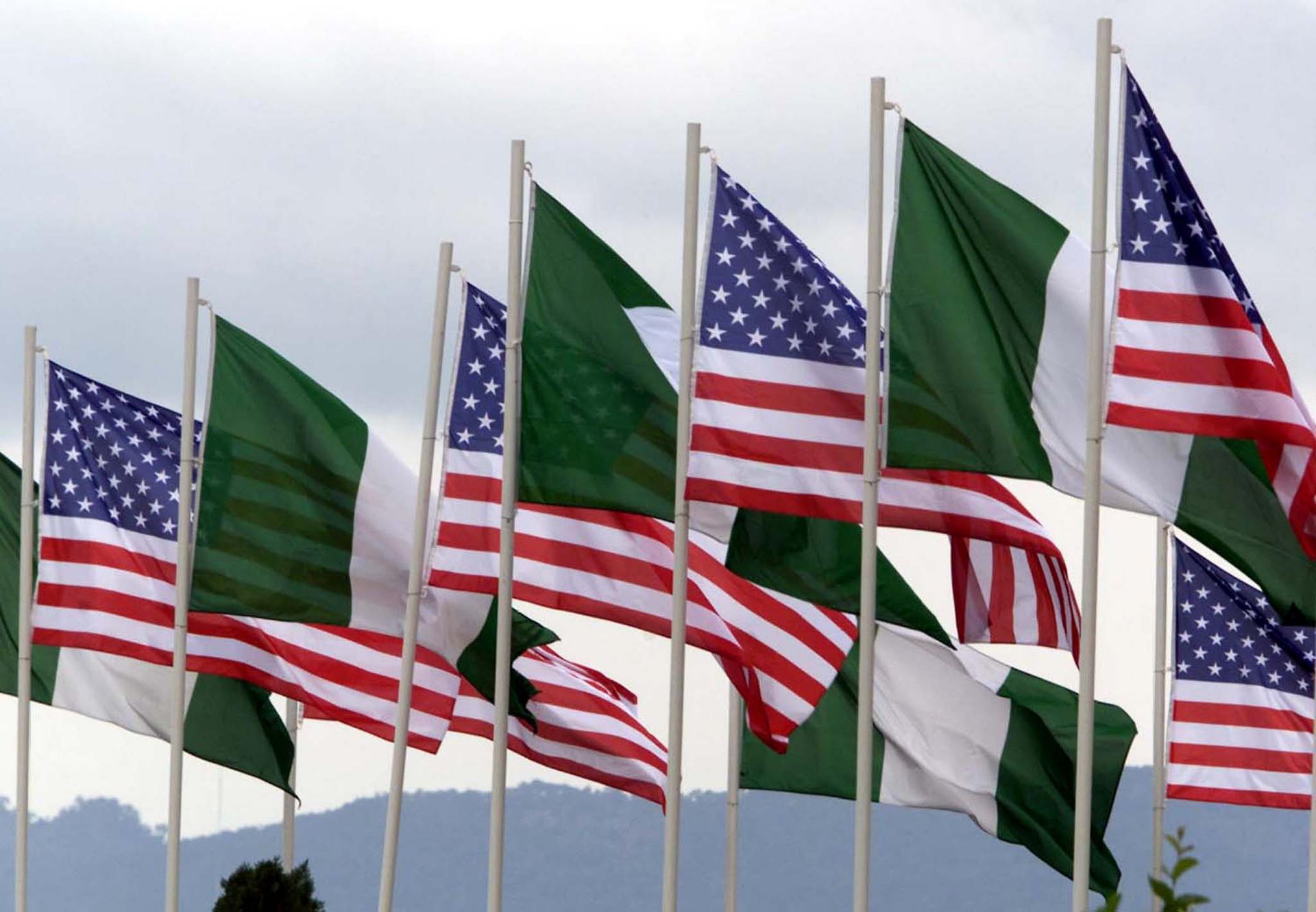 American and Nigerian flags fly next to each other in the center of Abuja August 24, 2000.