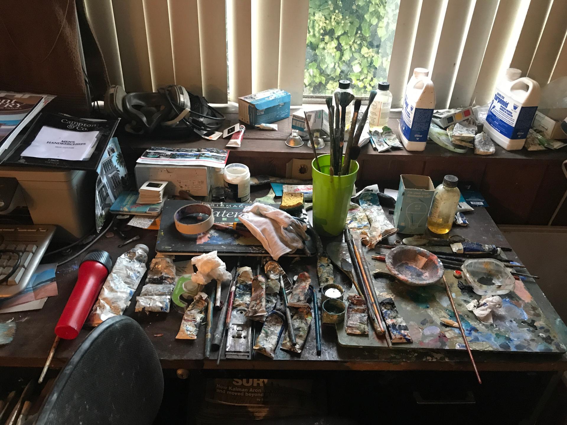 Kalman Aron typically paints at night in a small corner work space in his modest apartment in Beverly Hills.