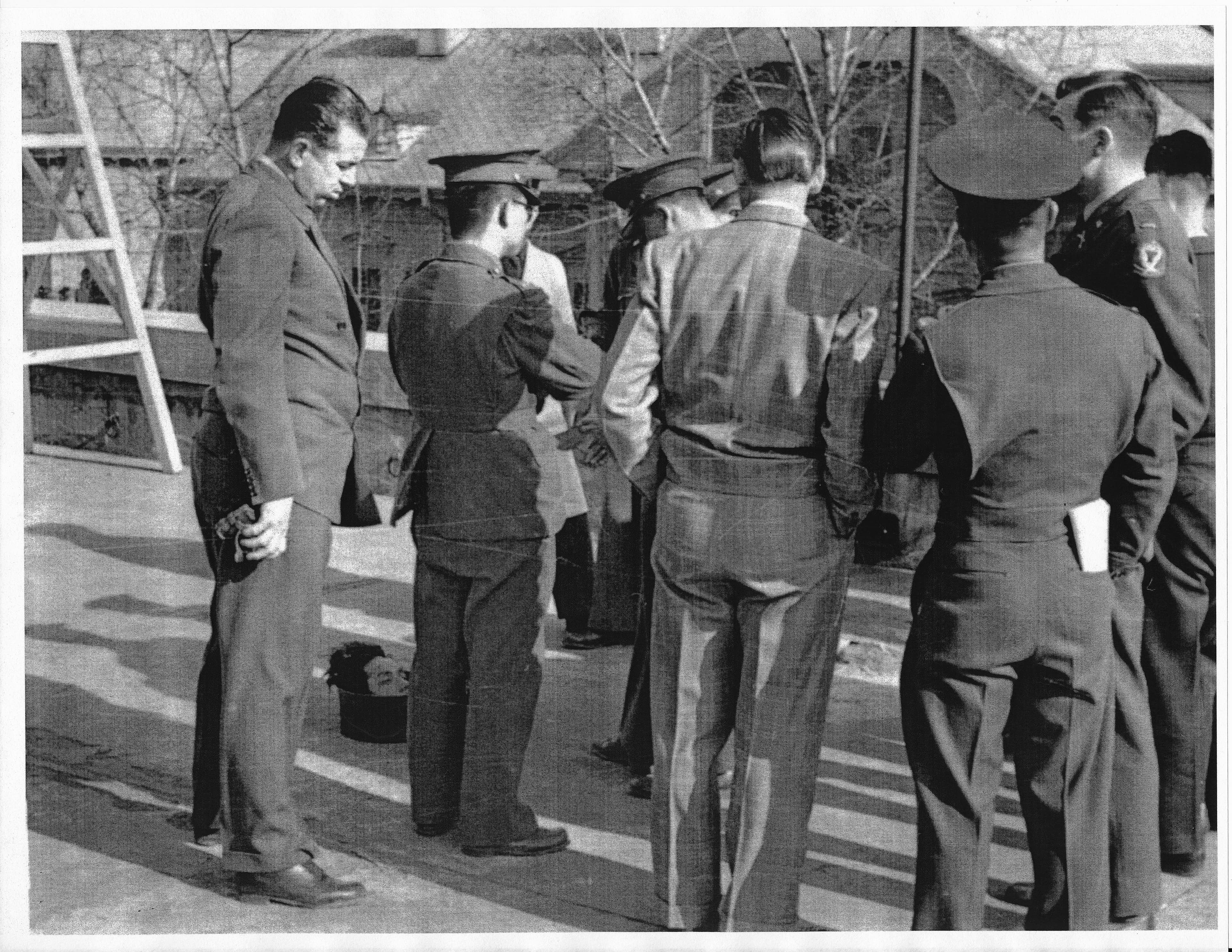 Nichols is seen here (far left) standing above severed human head, alongside unidentified US and South Korean officials in Seoul. Severed heads of Communist guerilla leaders were often sent to the South Korean capital to show progress in the civil war, Ha