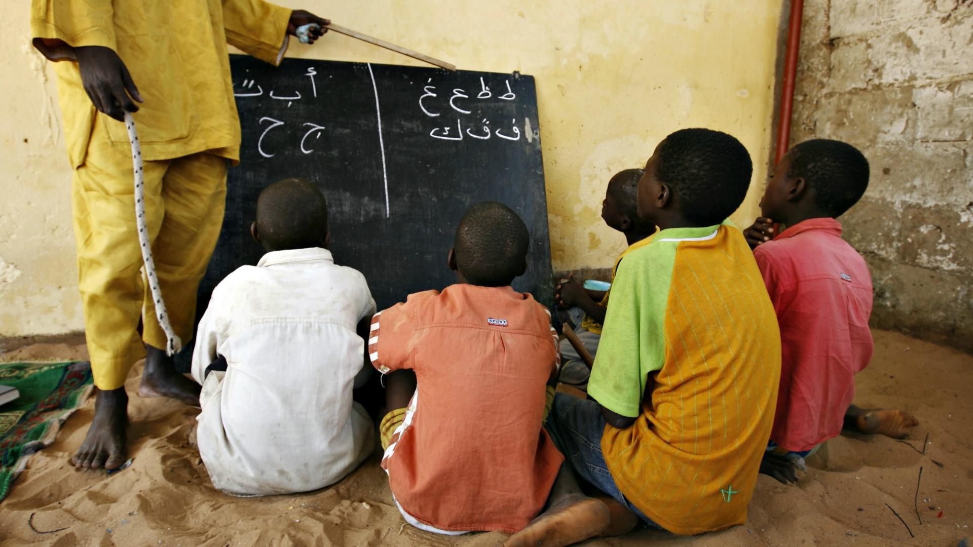 Students learn Arabic script at a Quranic school on the outskirts of Senegal's capital Dakar, May 7, 2008. 