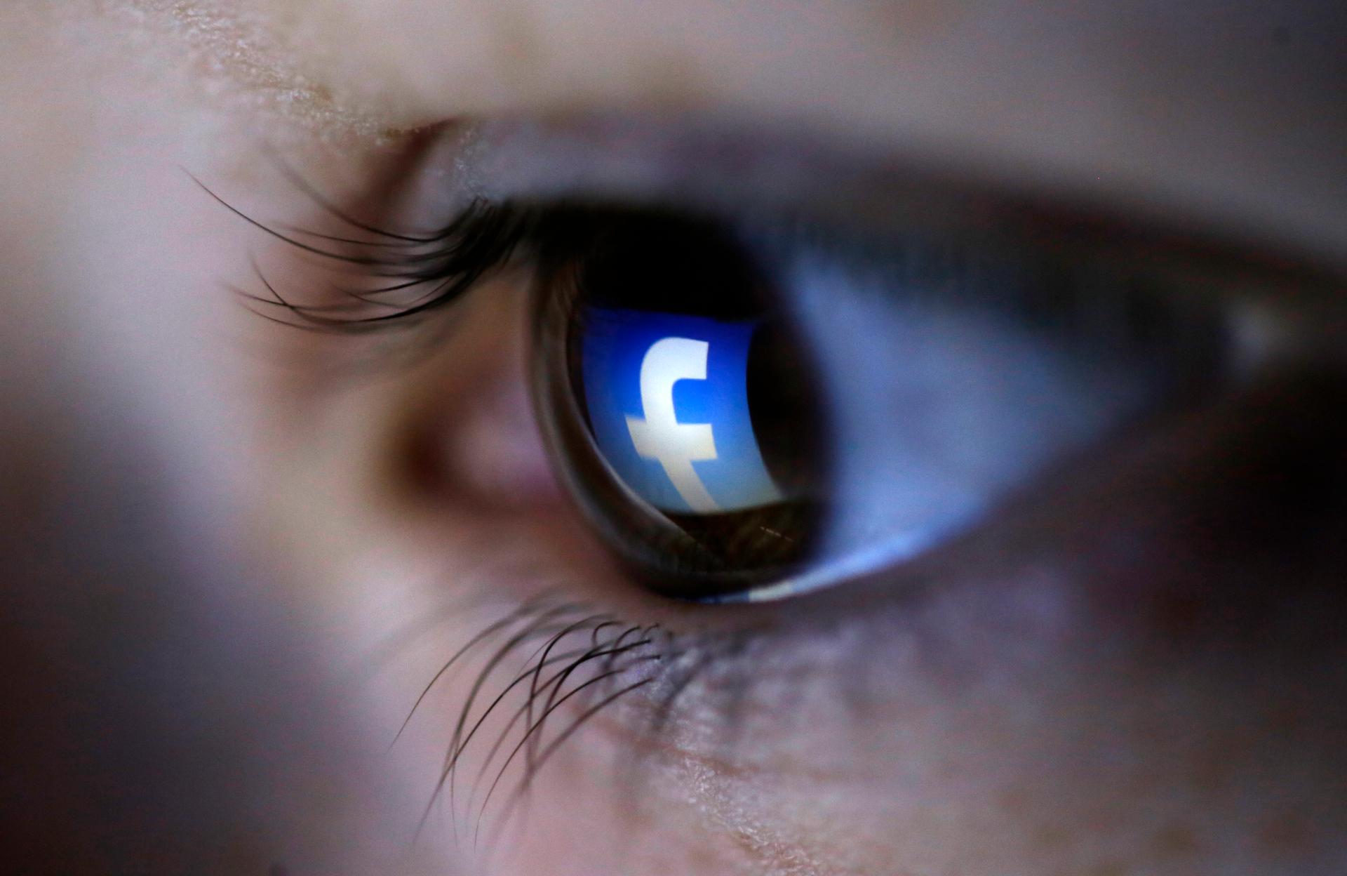 A picture illustration shows a Facebook logo reflected in a person's eye, in Zenica, March 13, 2015.