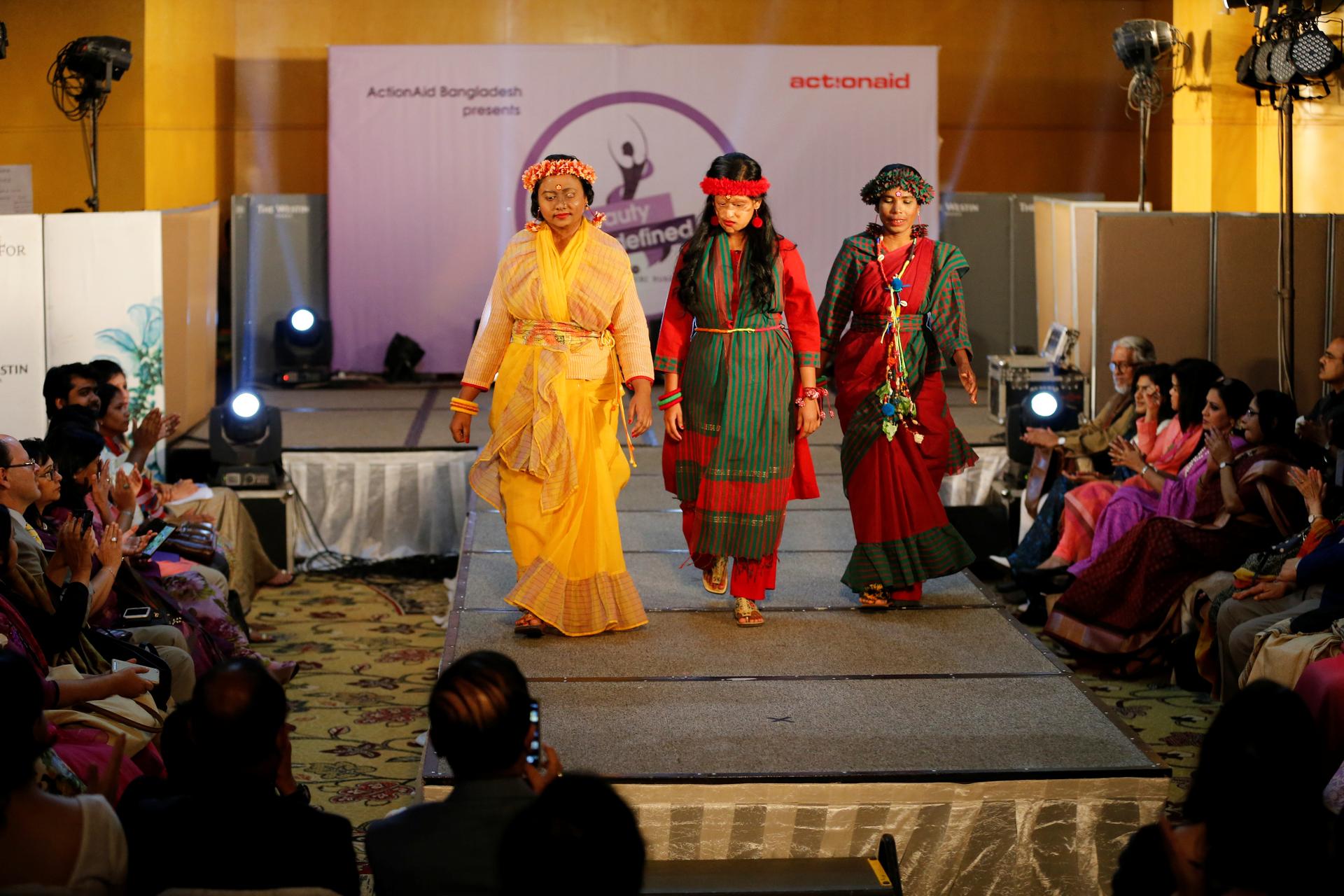 Acid attack survivors walk on the ramp as they participate in a fashion show titled “Beauty Redefined” organized by ActionAid Bangladesh in Dhaka.