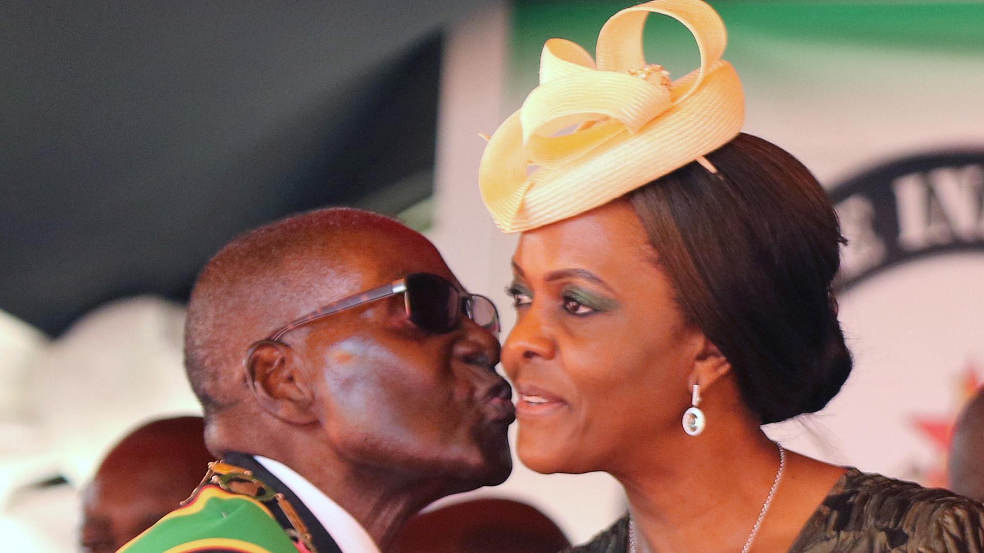 Robert Mugabe kisses his wife, Grace, at a rally to mark the country's 37th independence anniversary, in April
