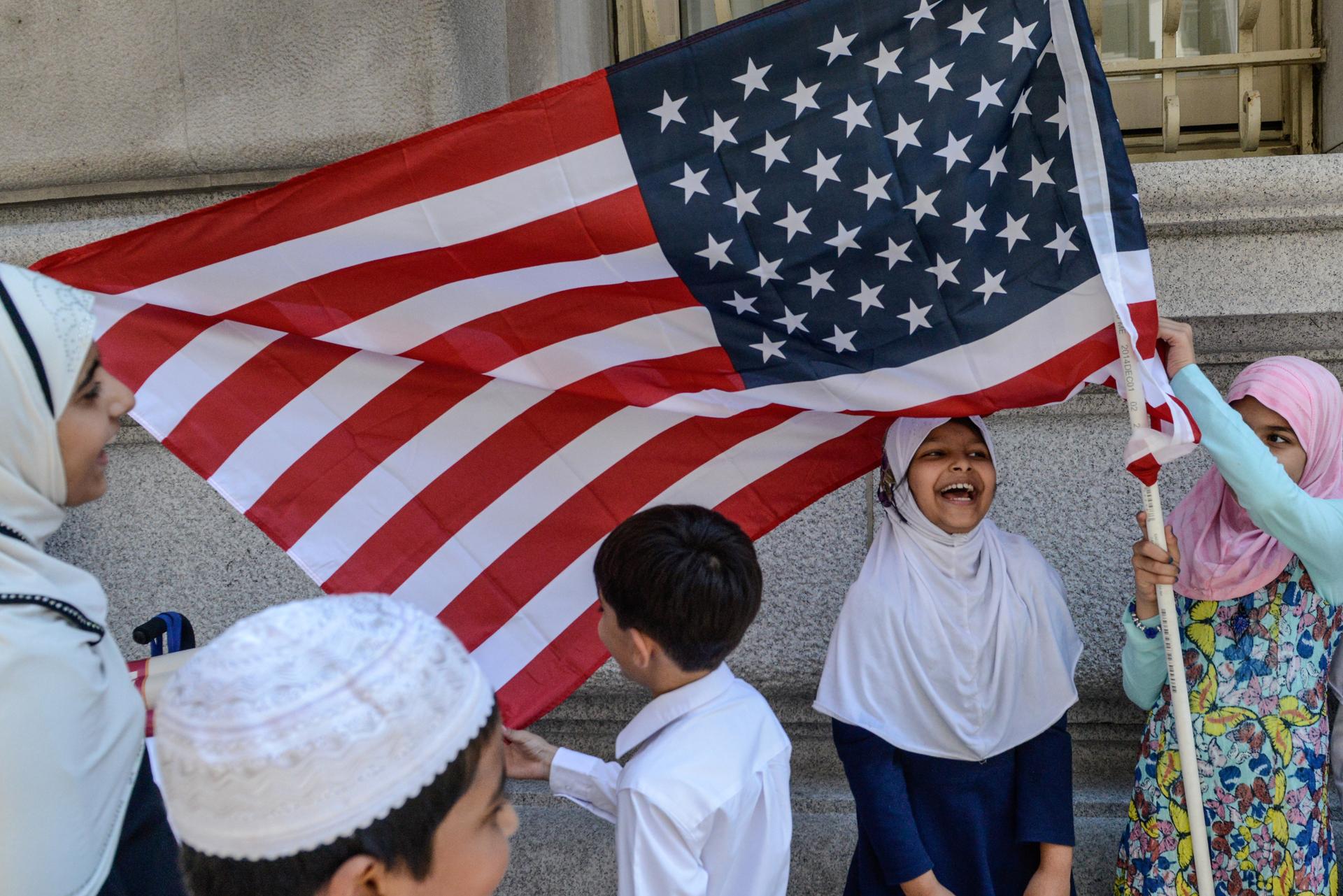 Children play near an American flag during the annual Muslim Day Parade in New York City.