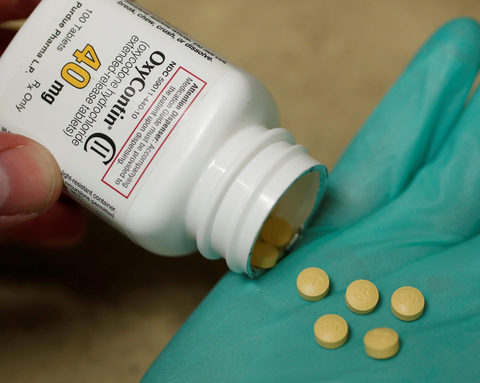 A pharmacist holds prescription painkiller OxyContin, 40mg pills, made by Purdue Pharma L.D. at a local pharmacy.