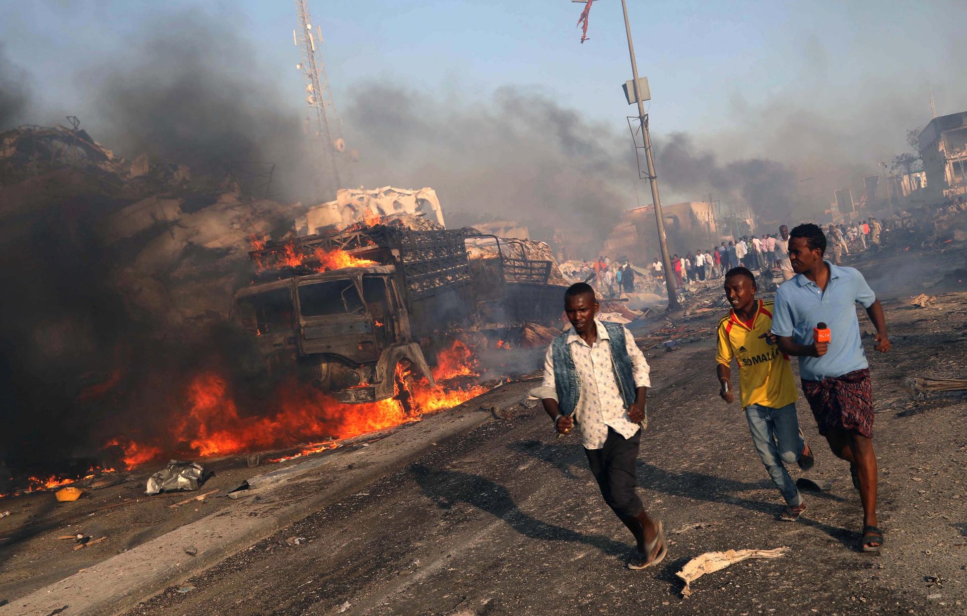 People are running from the scene of an explosion in the Hodan district of Mogadishu, Somalia, on Oct. 14, 2017.