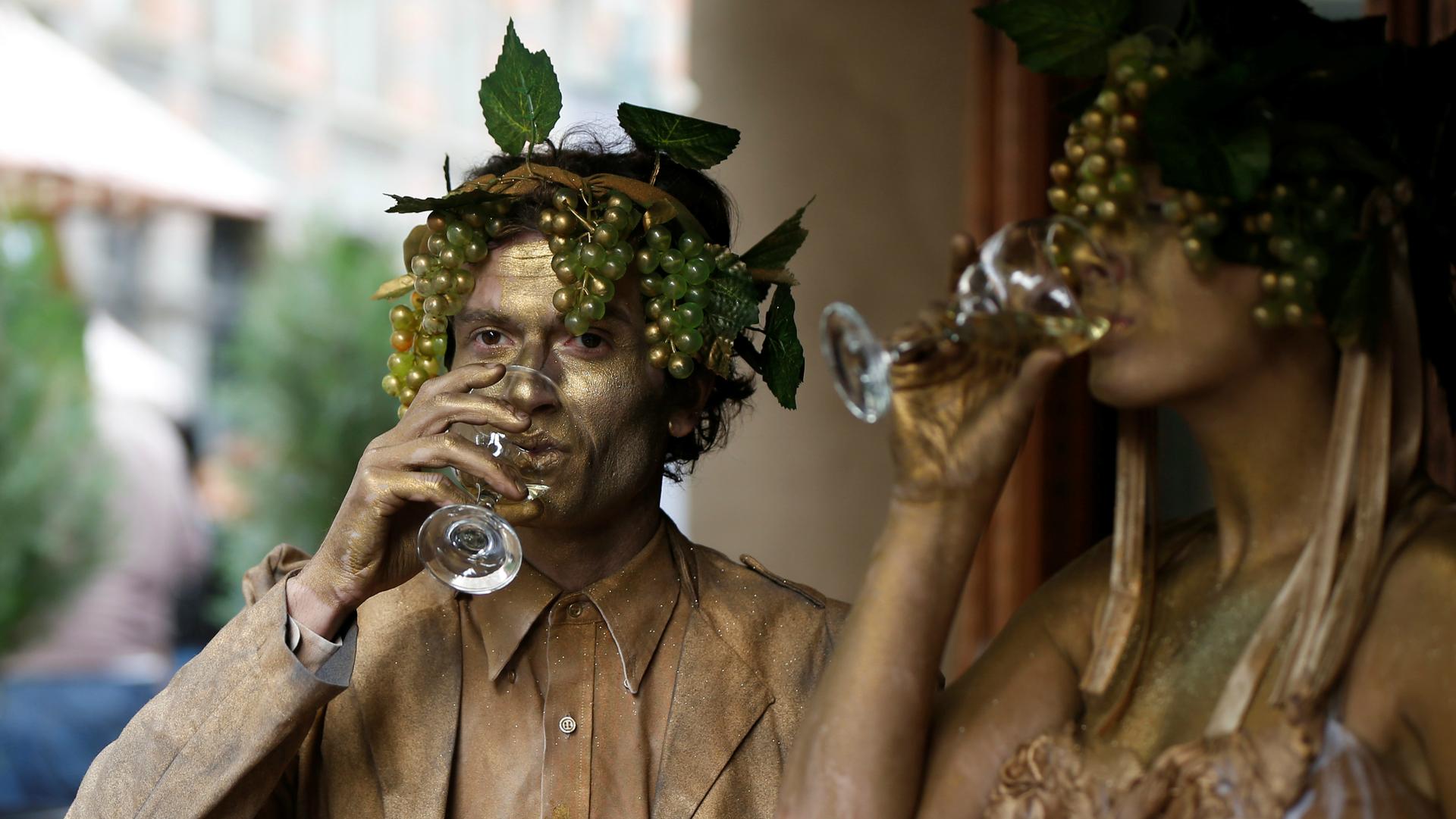 Performers drink wine during a wine festival in Tbilisi, Georgia, Oct. 15, 2017.