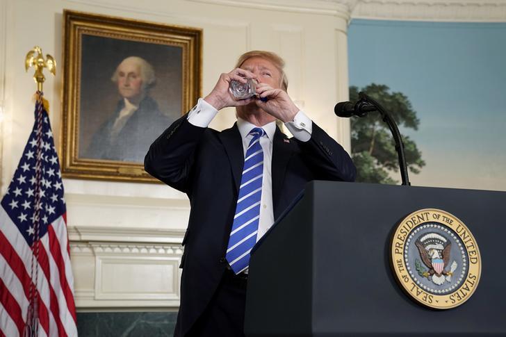 U.S. President Donald Trump takes a drink of water as he speaks about his recent trip to Asia in the Diplomatic Room of the White House in Washington, U.S., November 15, 2017. 