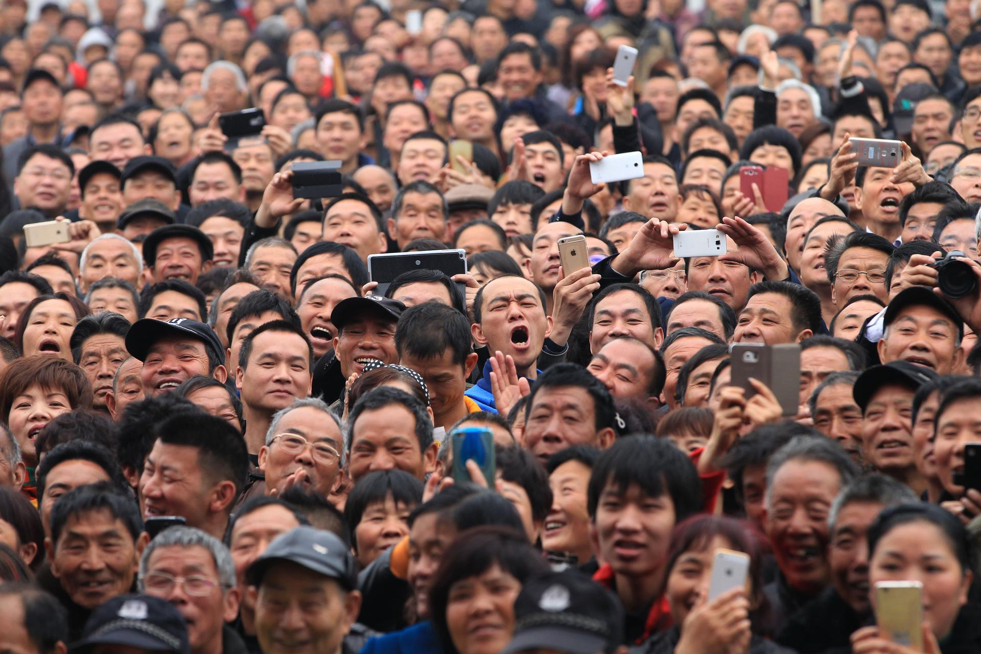 Spectators react as they watch a performance during a local martial arts cultural festival in  Zhejiang province. 