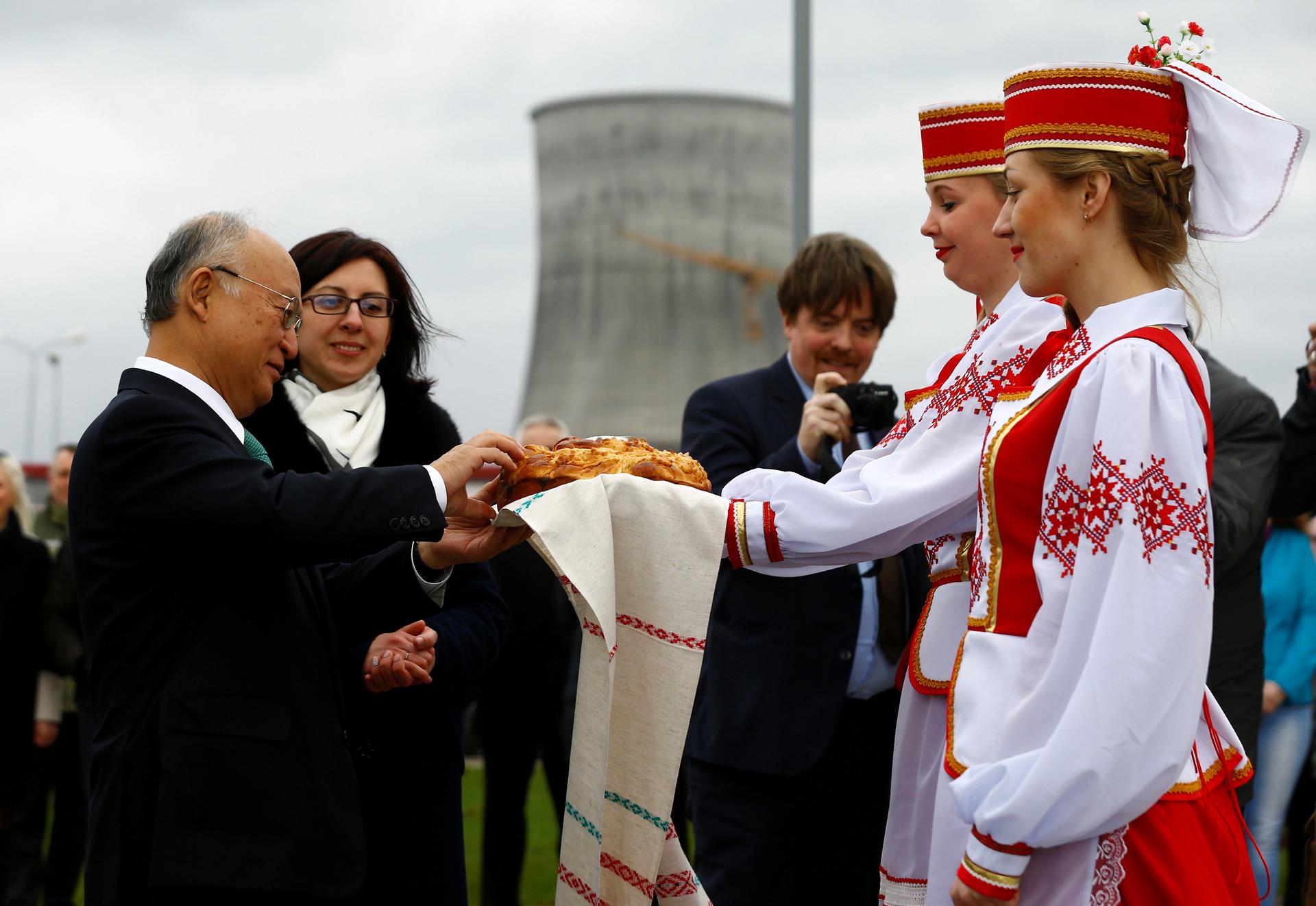 International Atomic Energy Agency (IAEA) Director General Yukiya Amano takes part in a traditional bread and salt ceremony during a visit to the Belarusian nuclear power plant