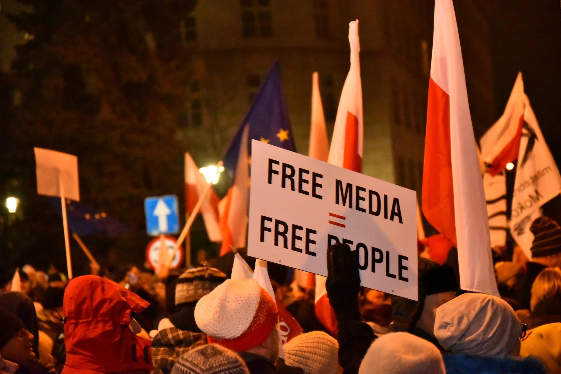 Polish protestors demonstrate their opposition to new restrictions for media in front of the parliament building in Warsaw, Poland.