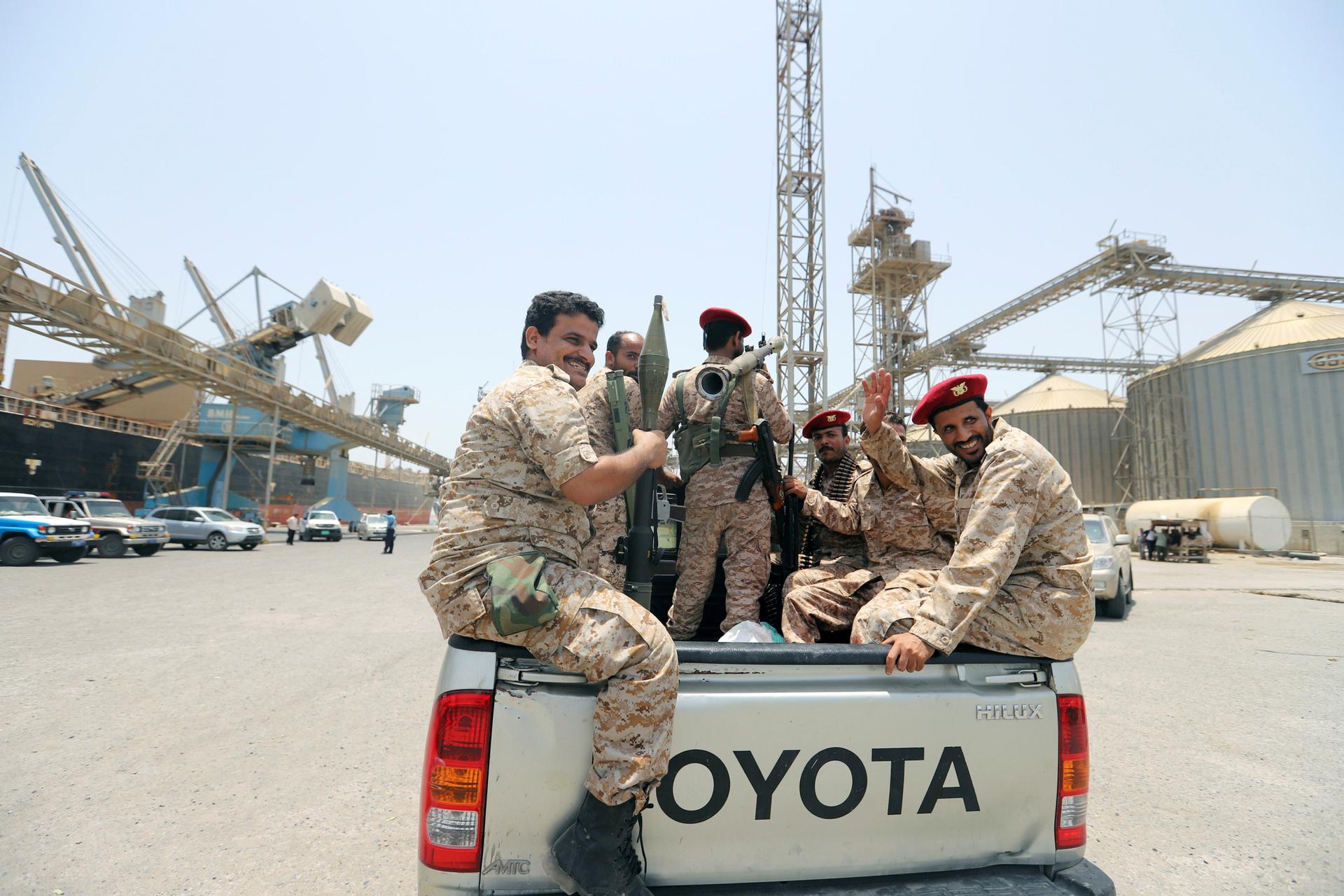 emen's Houthi movement forces ride in the back of vehicle during withdrawal from Saleef port in Hodeidah province