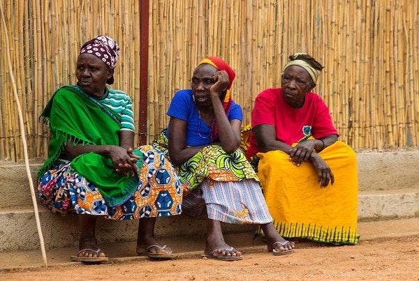 Genocide widows sit in the courtyard of Impinganzima care home, waiting for friends and family to visit.