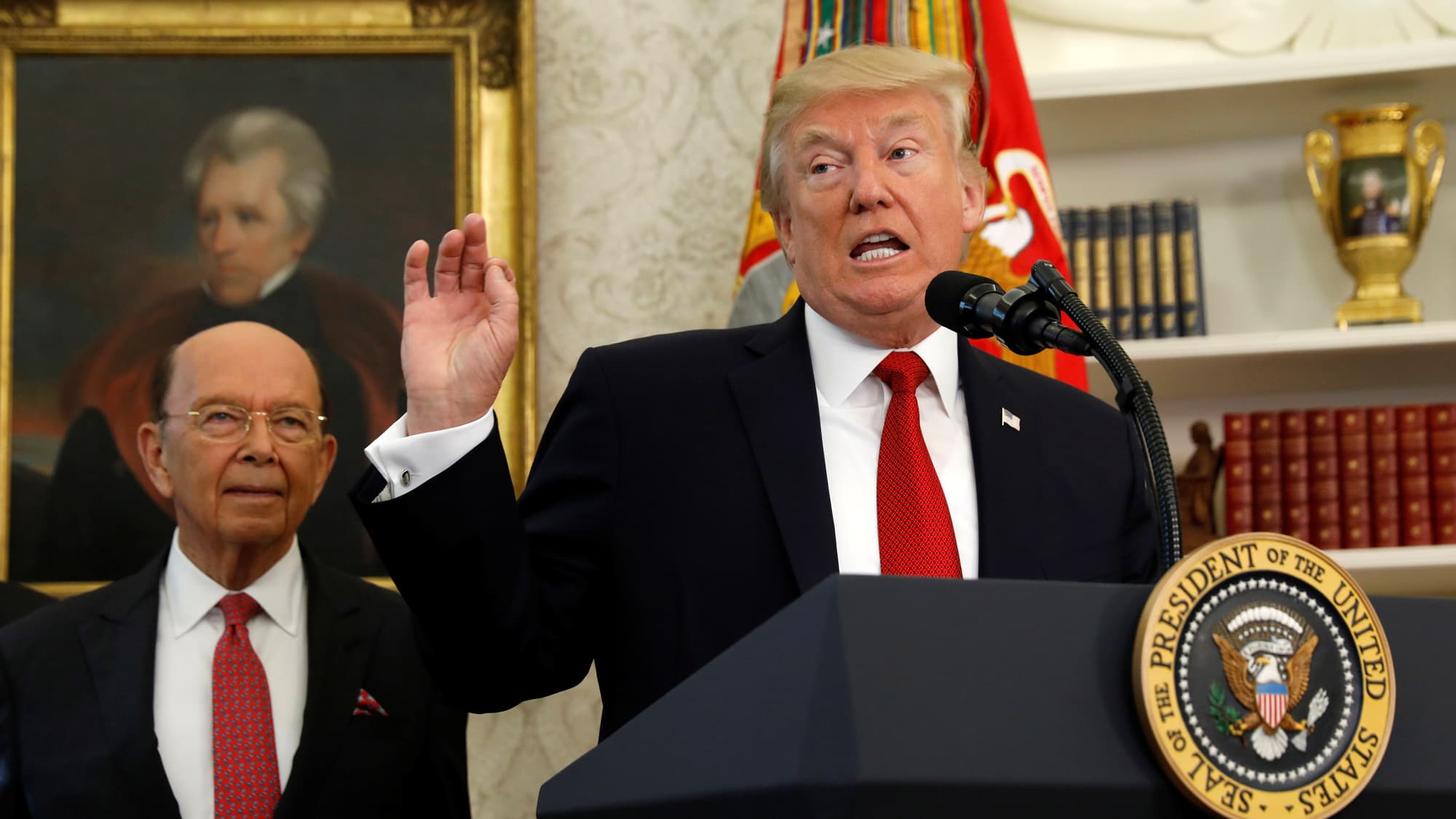 Commerce Secretary Wilbur Ross stands behind President Donald Trump at the White House, Oct. 24, 2017.