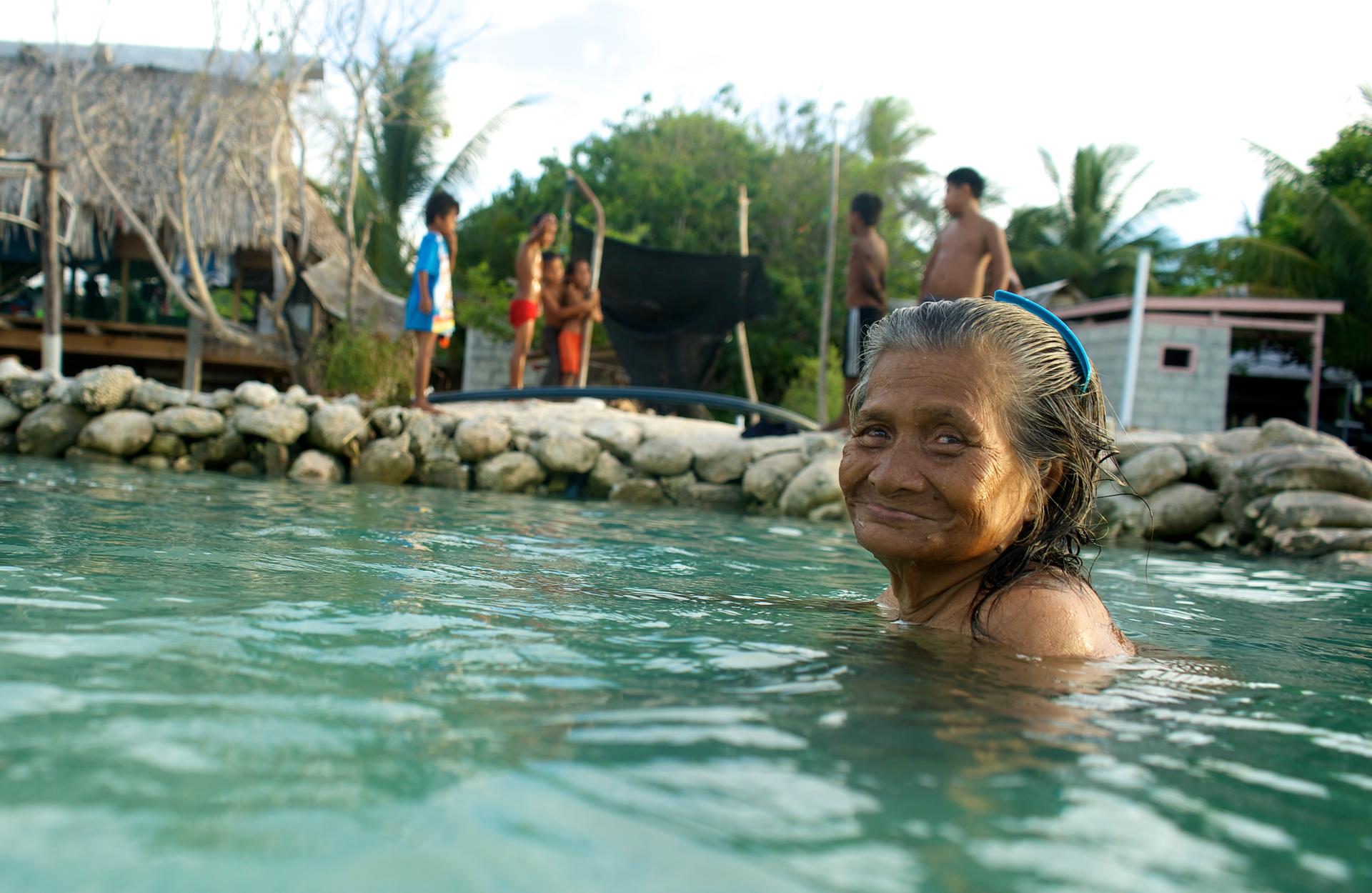 Woman swimming in Kiribati.