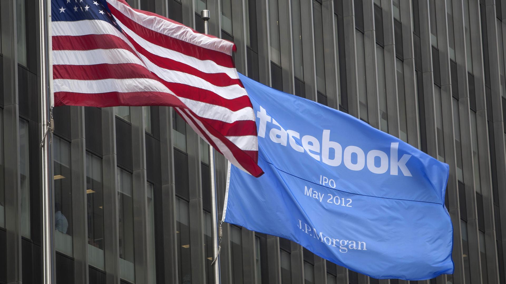 A flag announcing the IPO of Facebook flies next to the American flag outside the offices of JP Morgan in New York City, New York May 4, 2012.