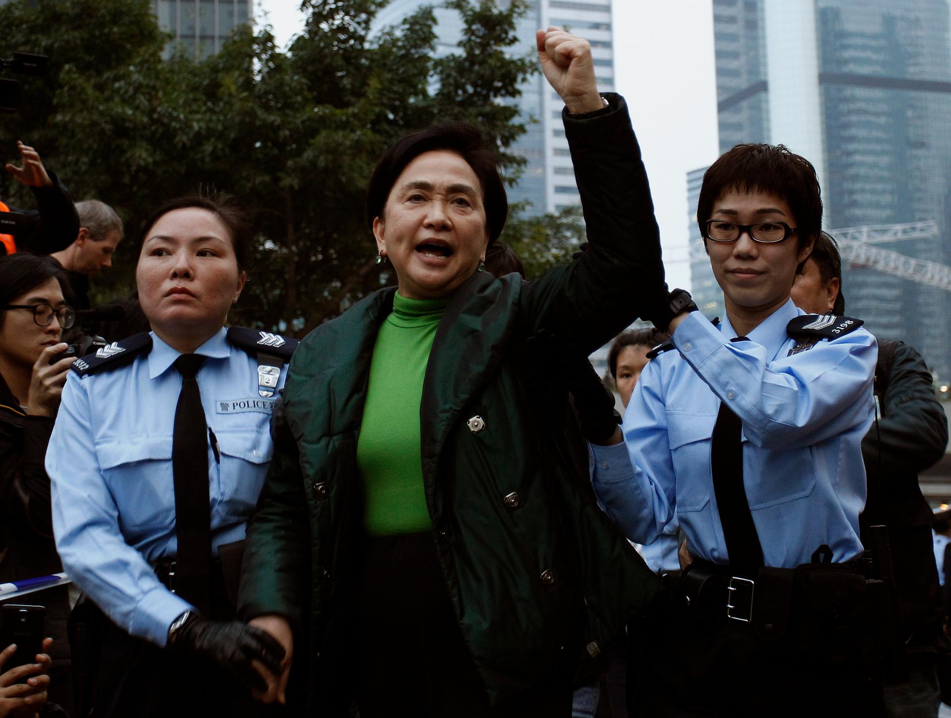 Emily Lau chants slogans as she is taken away by the police outside the government headquarters in Hong Kong December 11, 2014.