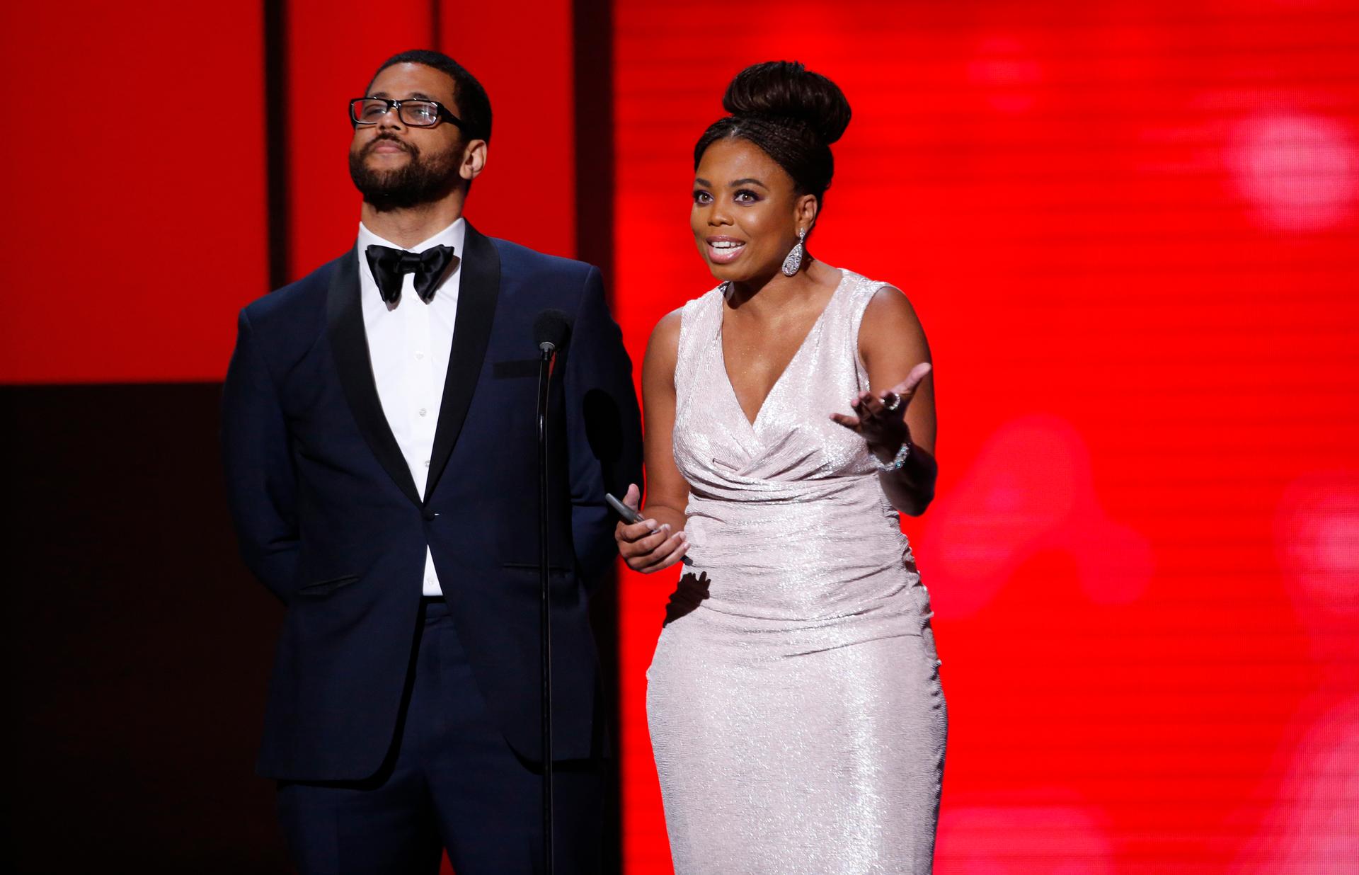 Presenters Jemele Hill and Michael Smith speak on stage at 49th NAACP Image Awards.