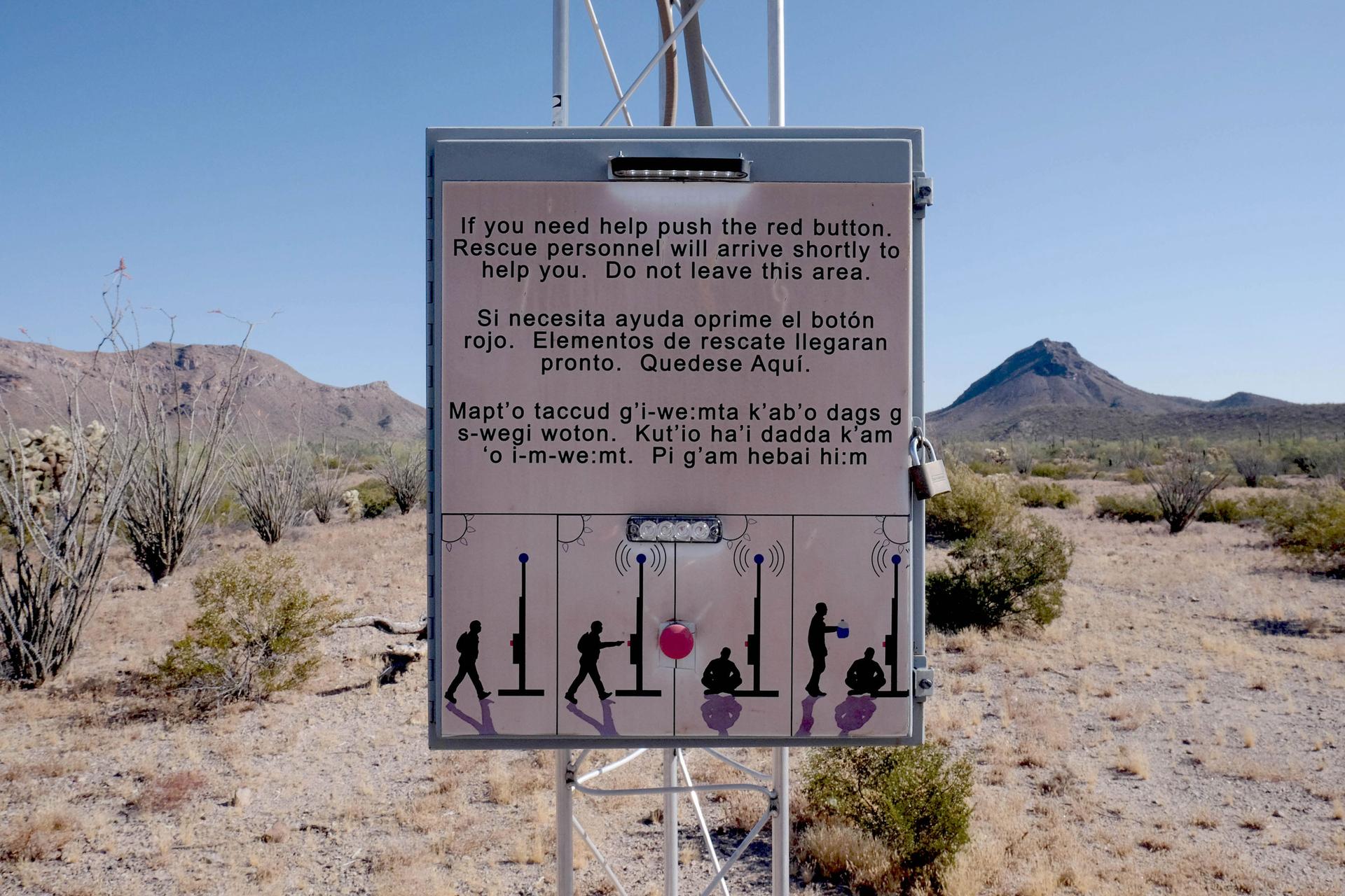 A sign in the desert reads, 