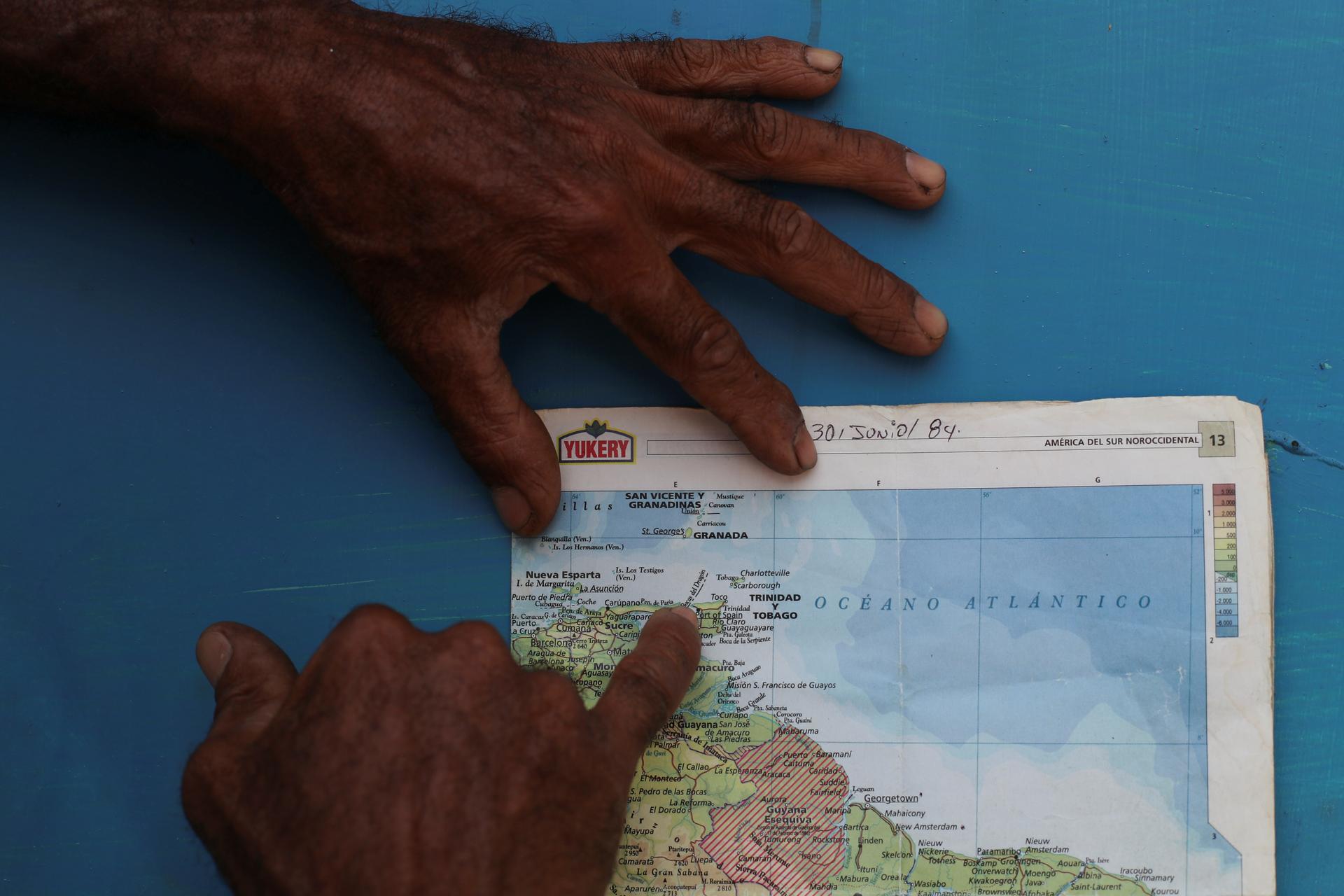 a man points out a dangerous sea passage on a map