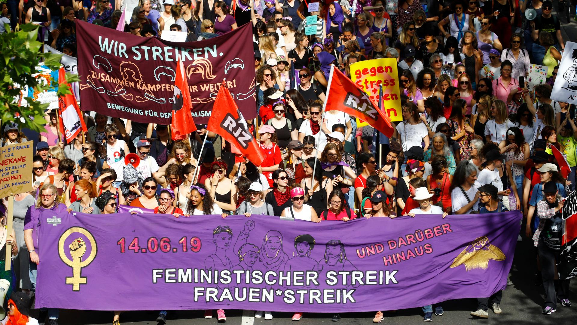 Protesters carry banners and placards at a demonstration during a women's strike (Frauenstreik) in Zurich, Switzerland June 14, 2019.