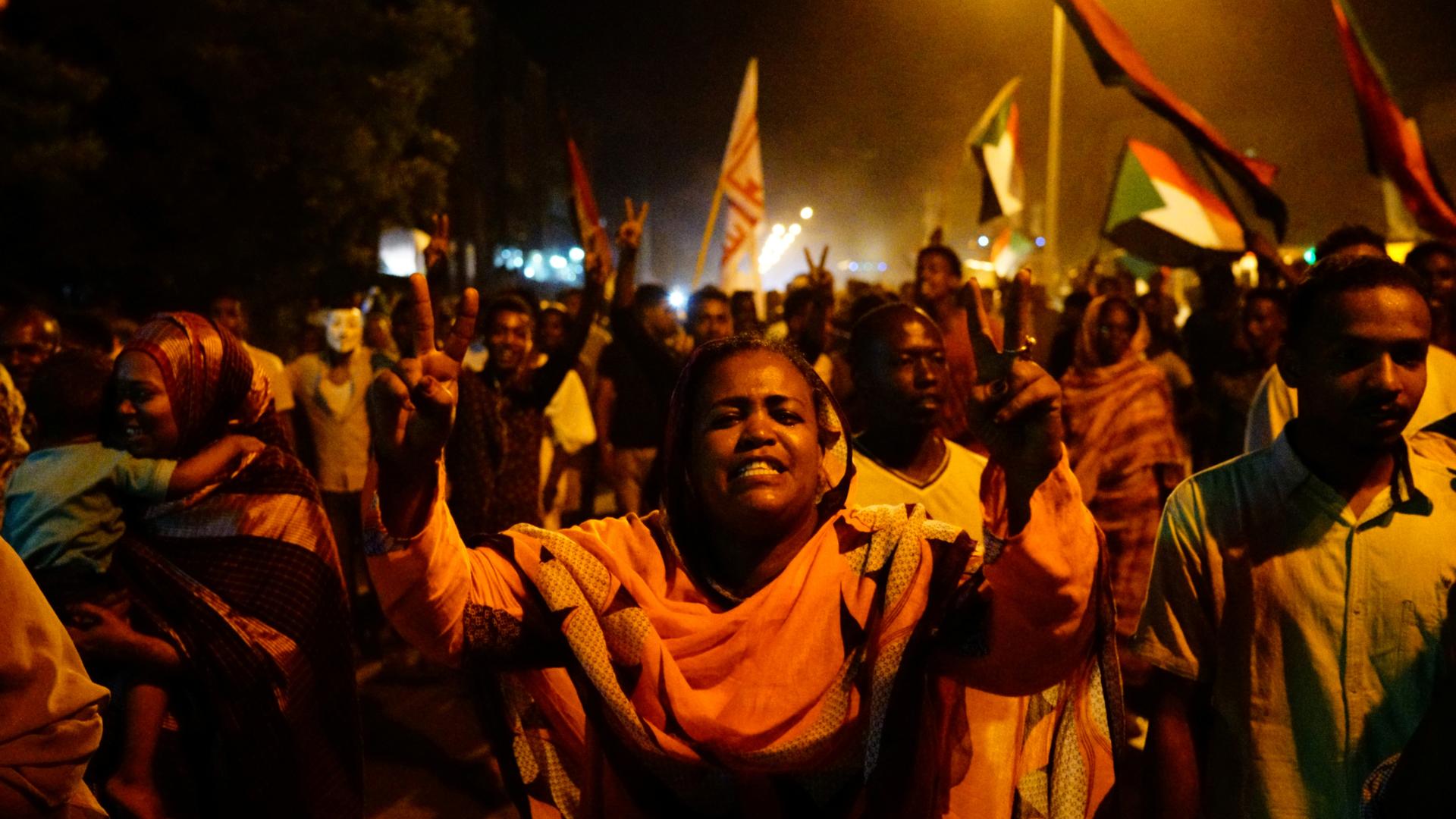 Sudanese people, seeking to revive a push for civilian rule in ongoing tumult since the overthrow of former President Omar al-Bashir more than two months ago, chant slogans and wave Sudanese flags during a demonstration in Khartoum, Sudan, June 21, 2019. 