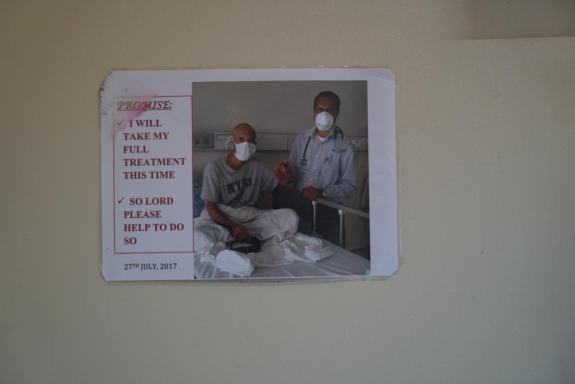 An image of a TB patient and his doctor hung on a wall
