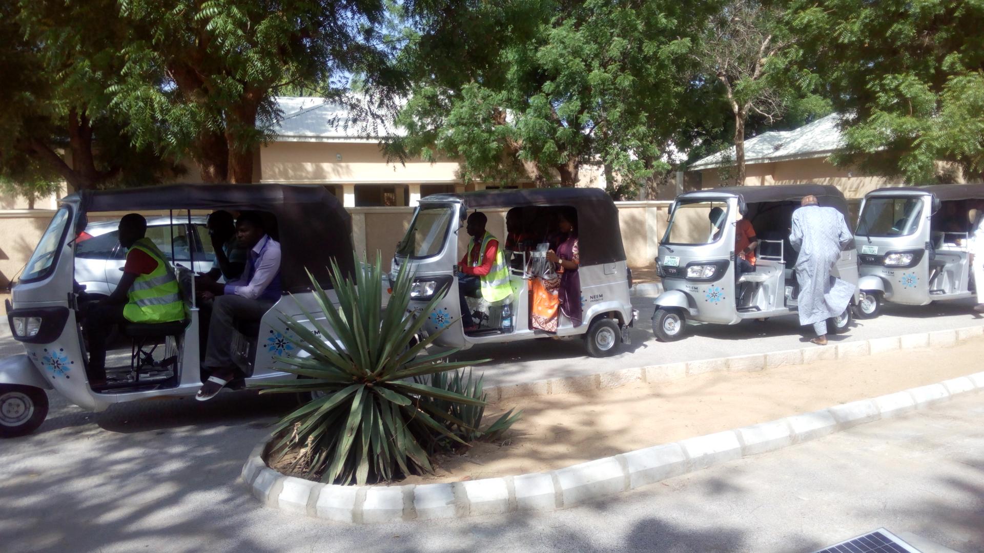 Counselors line up in tuk-tuks for house visits