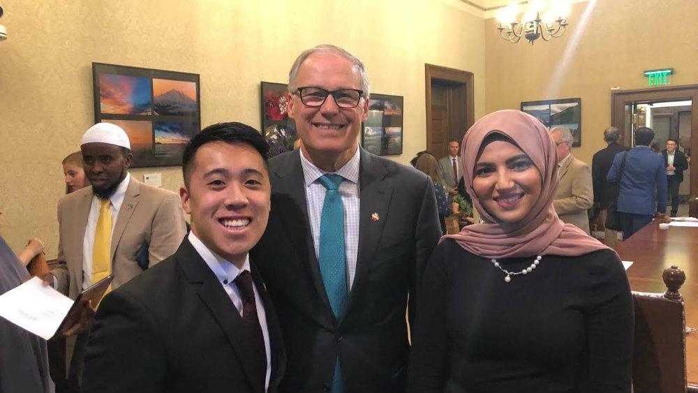 Two students taking a picture with the Washington State governor