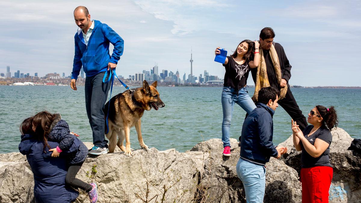 Iranian refugee families enjoy a Sunday picnic at Toronto Humber Bay Park. 