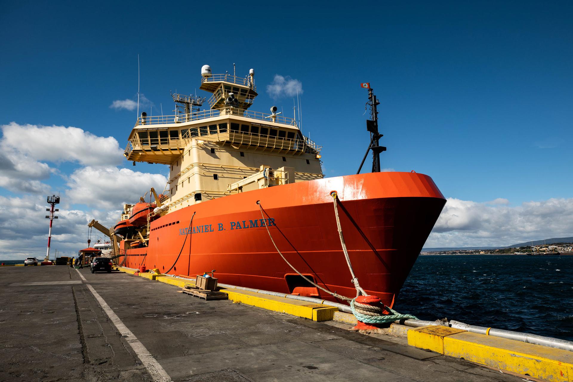 The bright orange Nathaniel B Palmer ship is docked