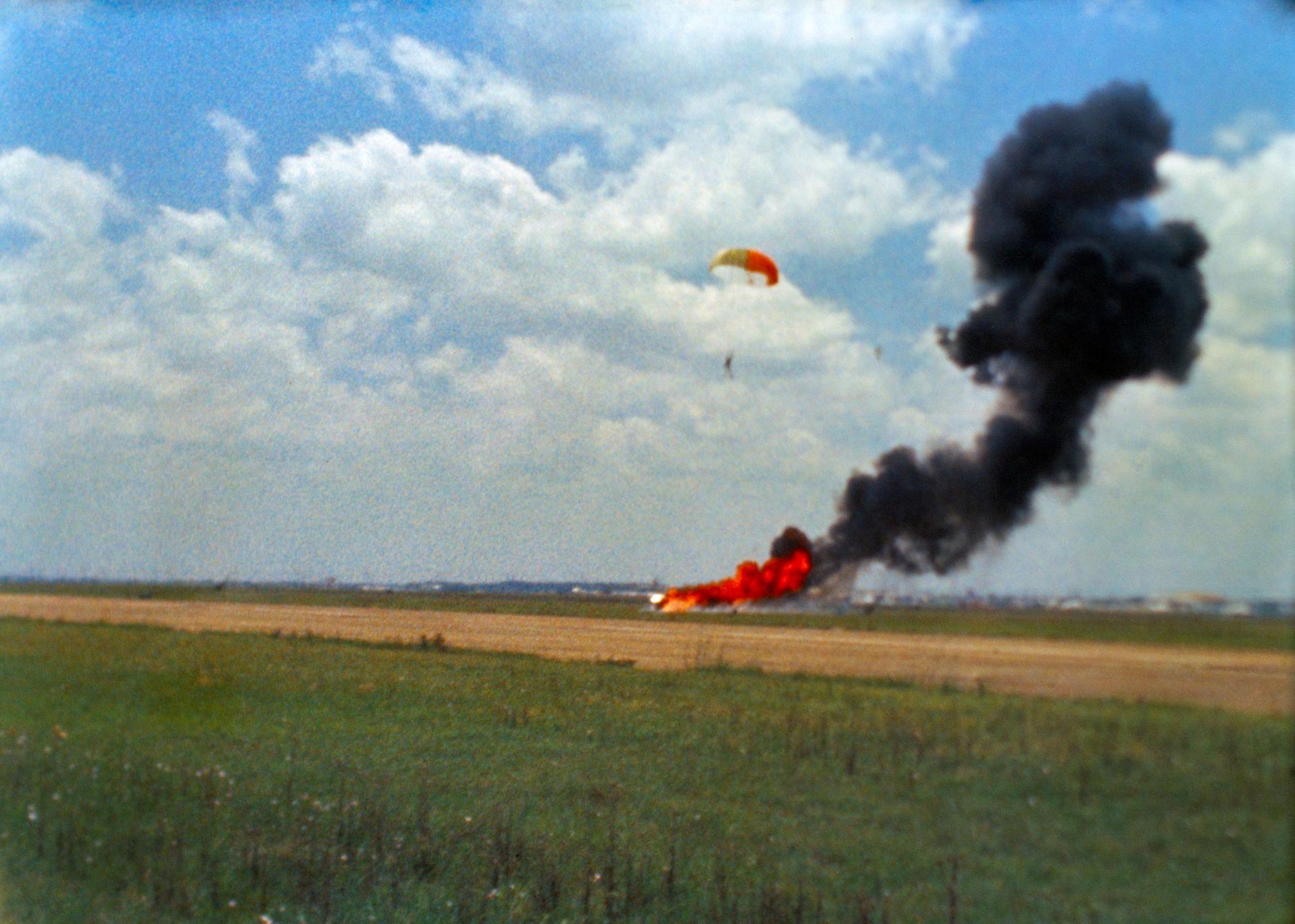 An airfield is shown with Neil Armstrong and his parachute landing.