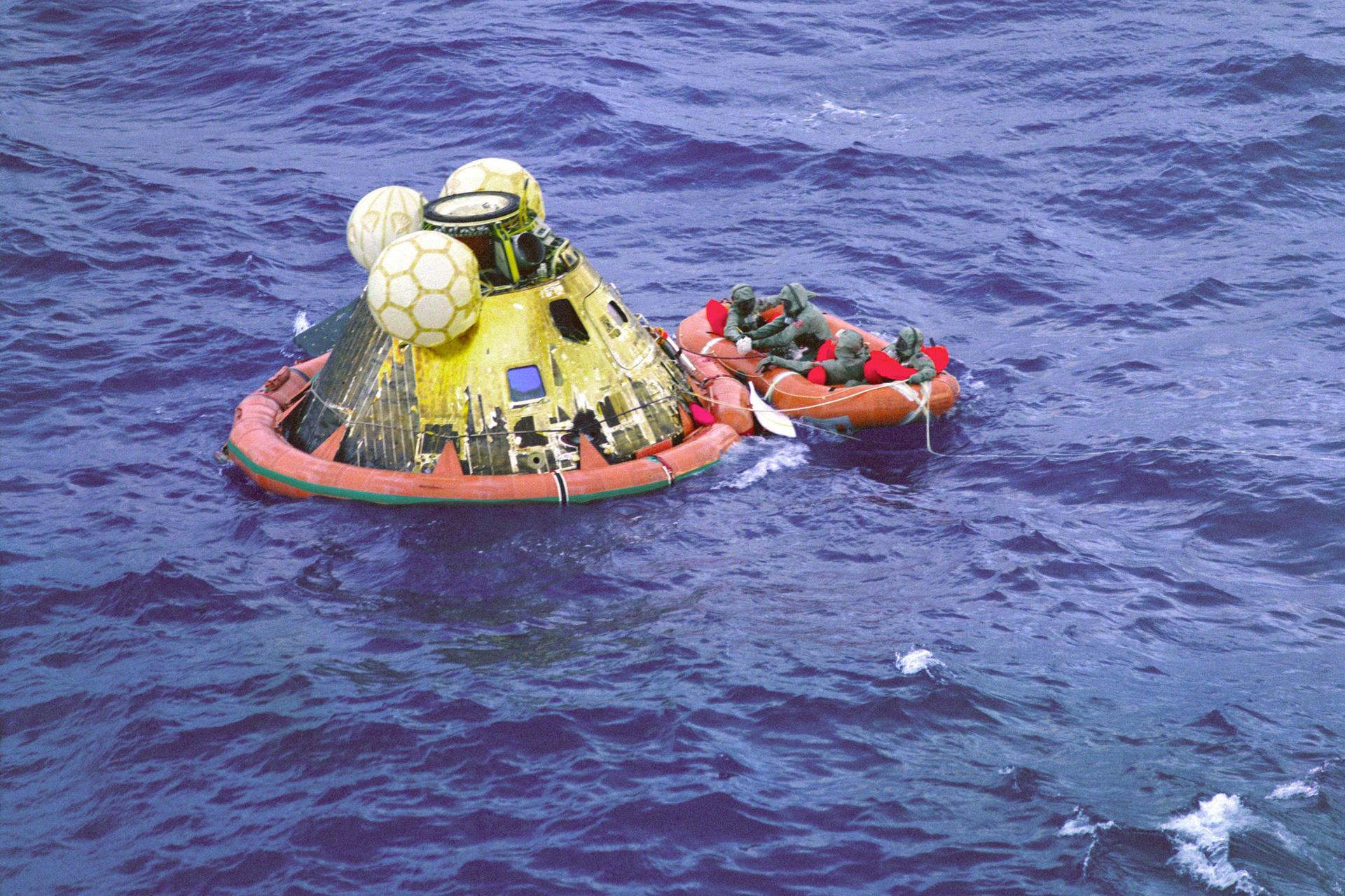 A small orange raft is shown with astaurants aboard, floating next to luna modual.