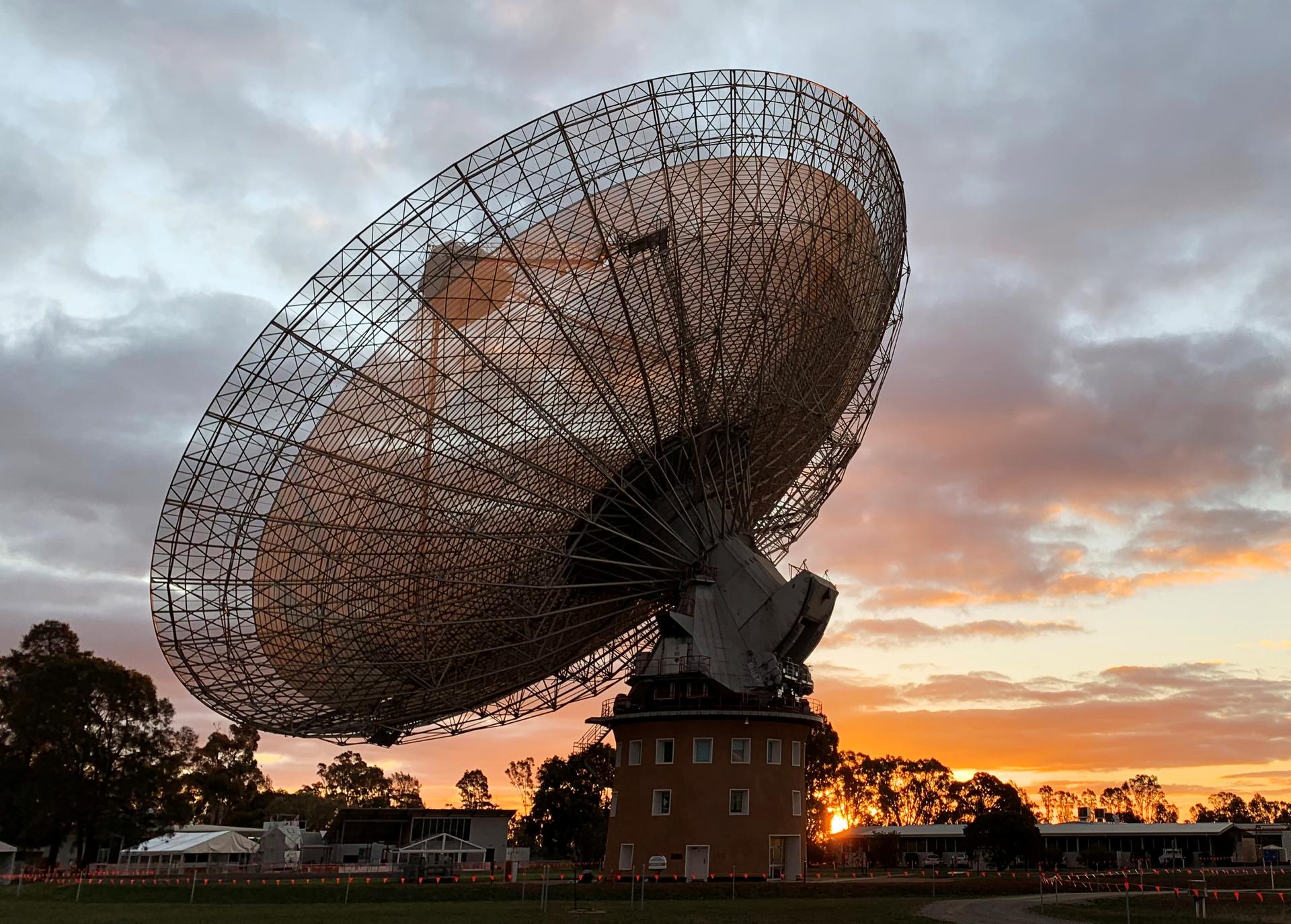 A radio telescope dish at sunset. 