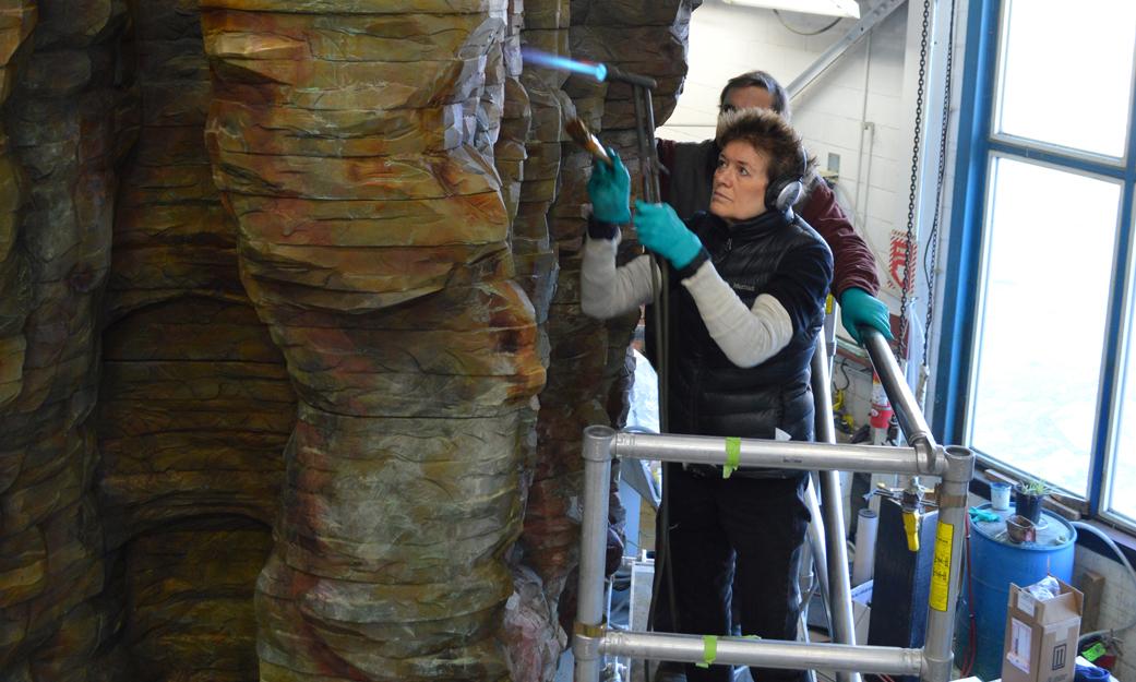 Ursula von Rydingsvard climbs a ladder to work on her sculpture “Bronze Bowl with Lace,” 2013.
