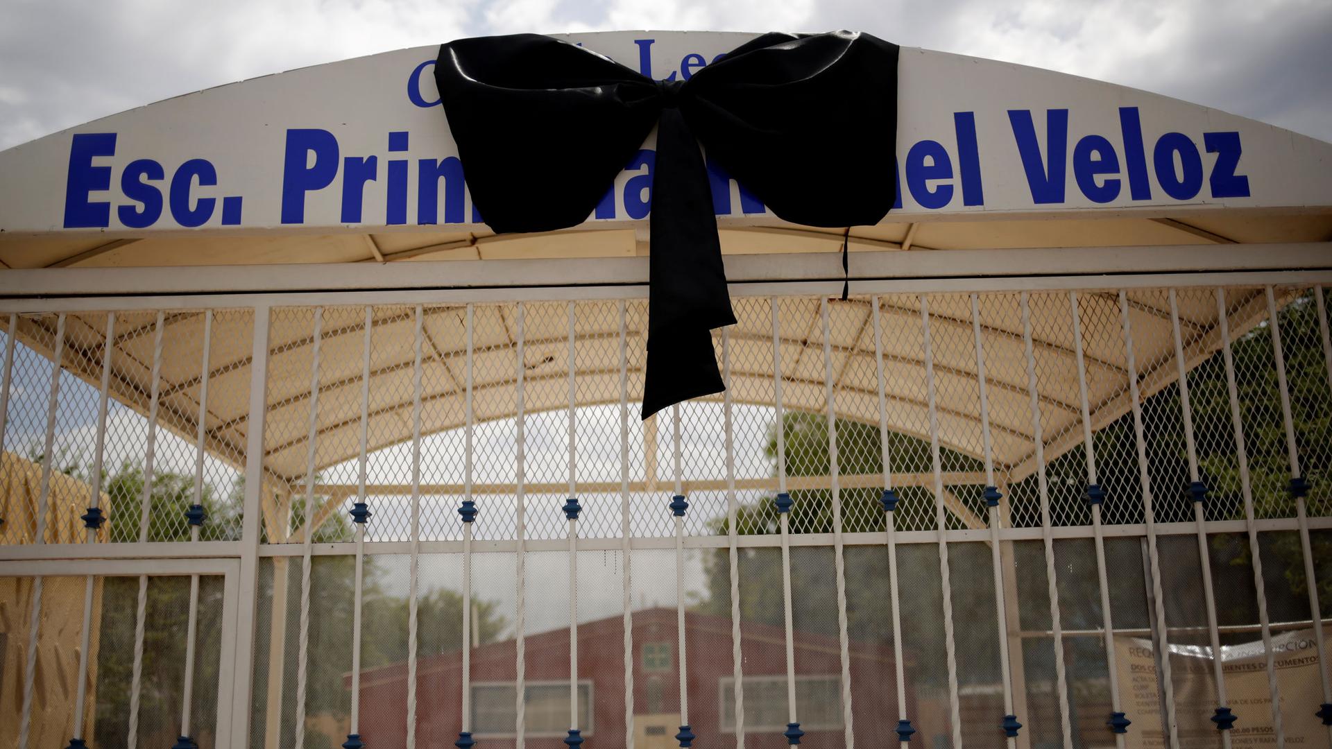 A big black ribbon adorns the gate of the Rafael Veloz elementary school in Ciudad Juárez, Mexico.