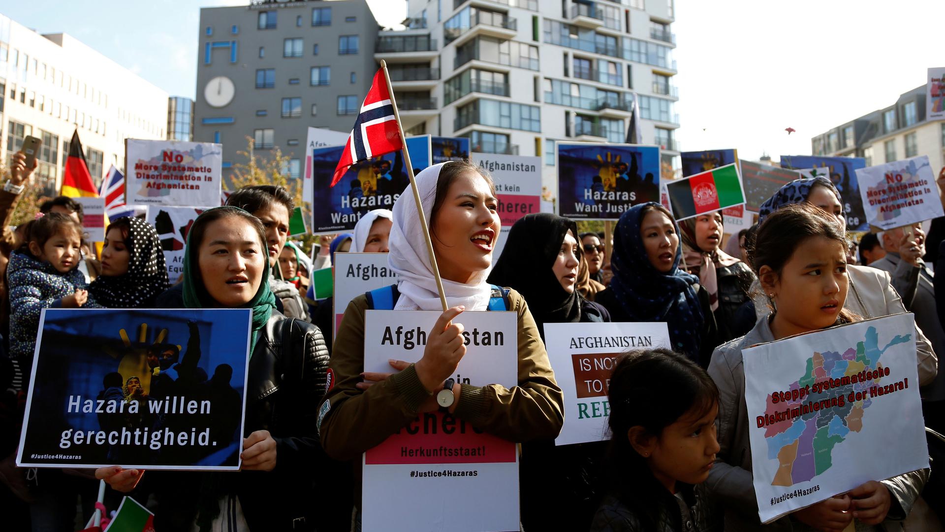 Demonstrators hold placards and attend a rally outside the Brussels Conference on Afghanistan, in Belgium, October 5, 2016.