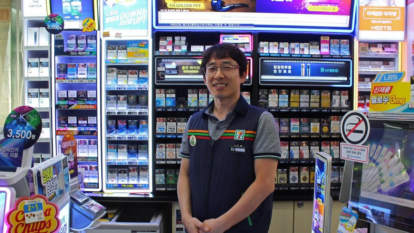 Man stands in 7-Eleven in work vest 