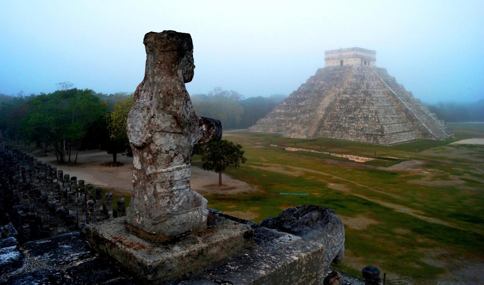 A Mayan temple is seen on a foggy morning.