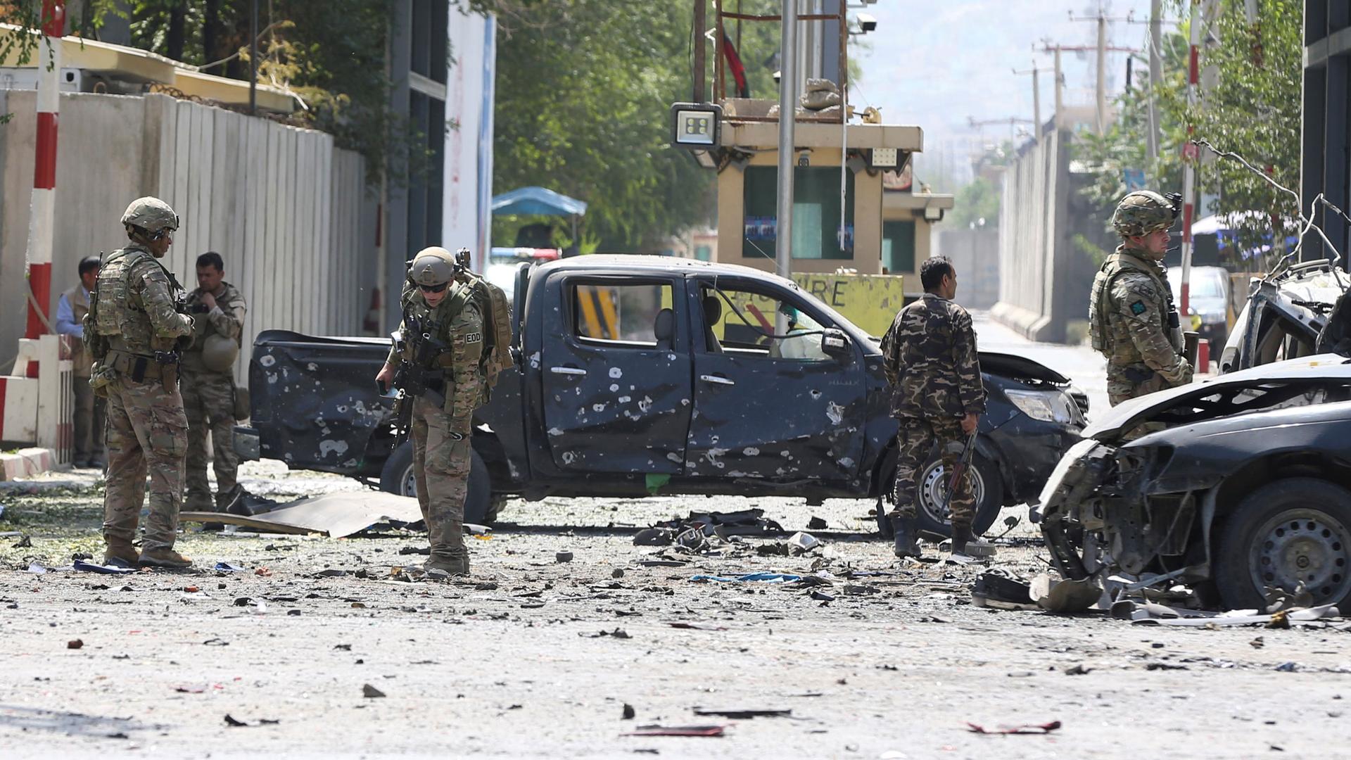 Foreign troops with NATO-led Resolute Support Mission investigate at the site of a suicide attack in Kabul, Afghanistan, on Sept. 5, 2019. 