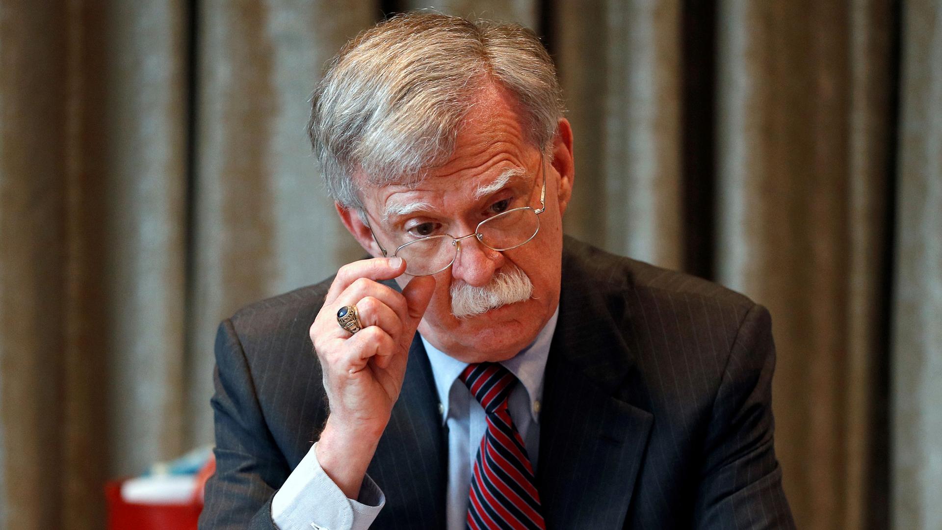 John Bolton adjusts his glasses in a file photo 