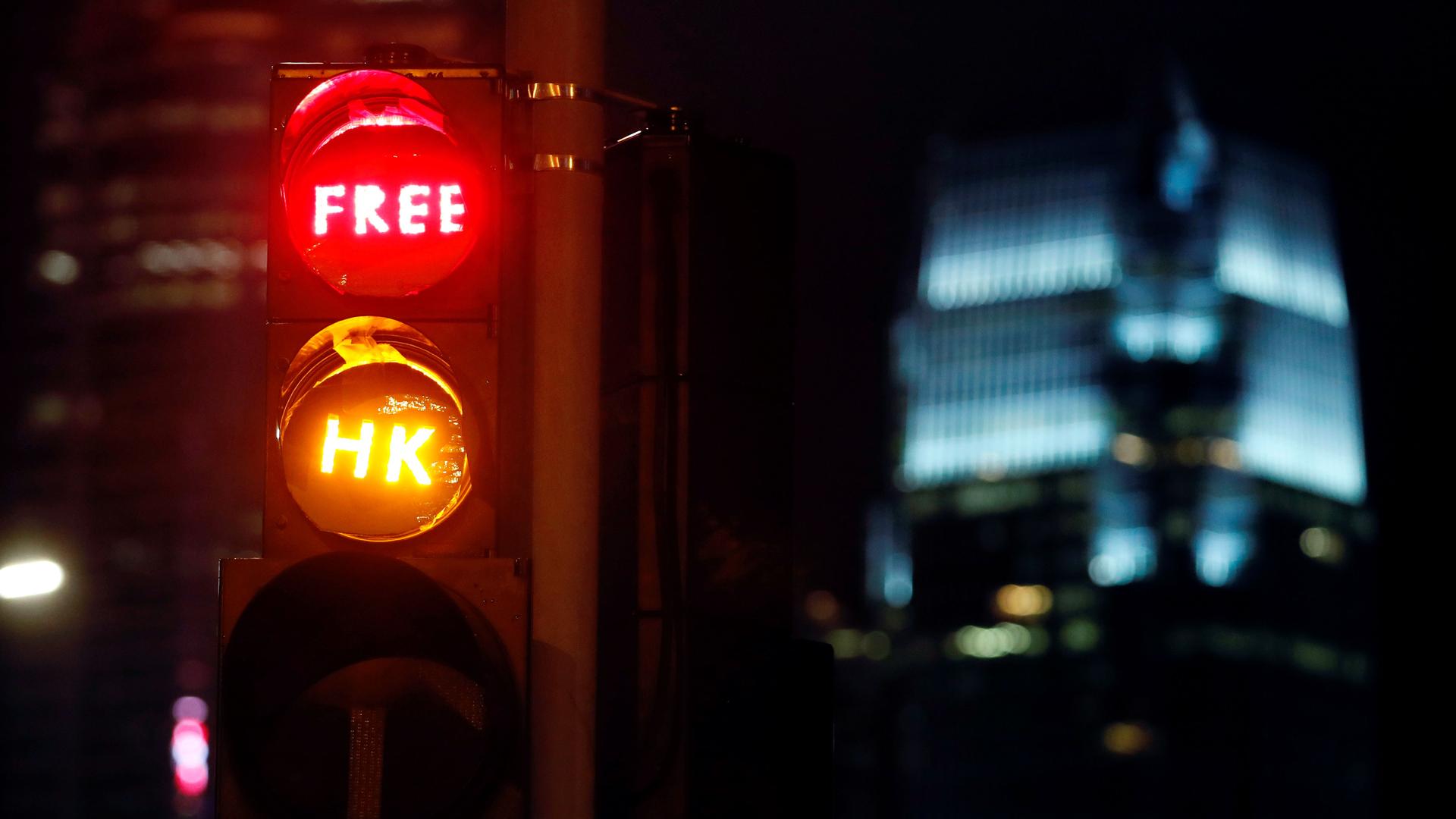 A traffic light reading "Free HK" across the red and yellow lights. 