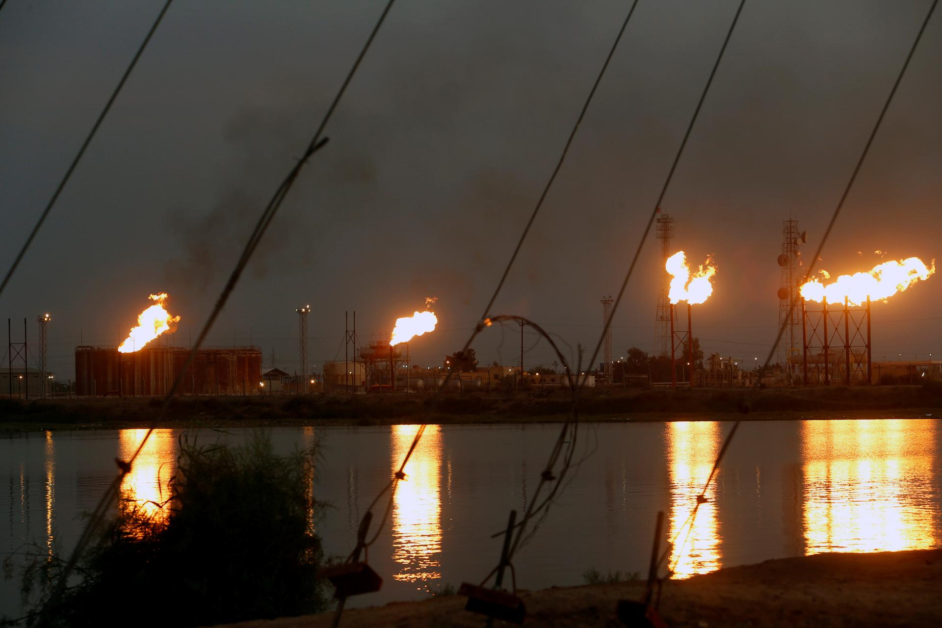 Flames emerge from flare stacks at Nahr Bin Umar oil field, north of Basra, Iraq, on Sept. 16, 2019.