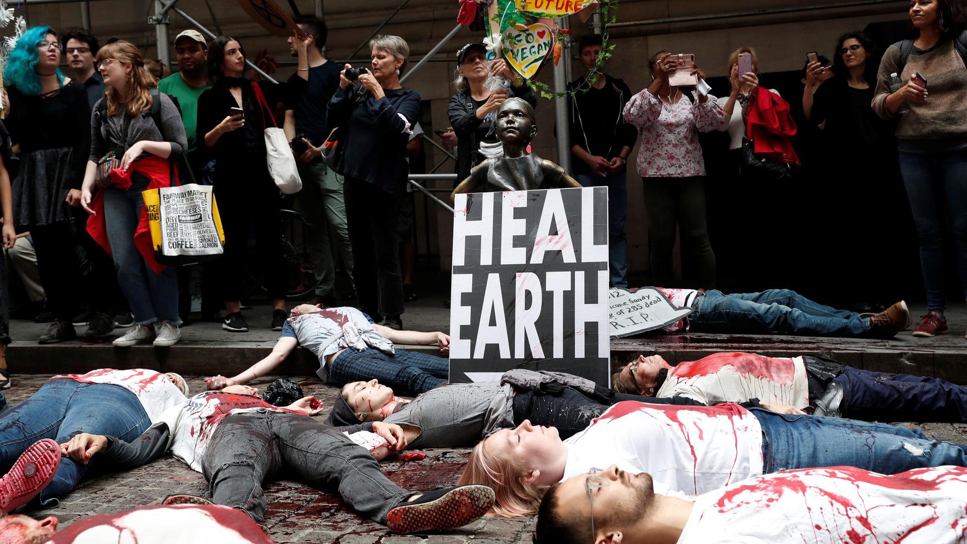 Climate change activists protest at the Wall Street Bull in Lower Manhattan during Extinction Rebellion protests in New York City, New York, US, on Oct. 7, 2019.
