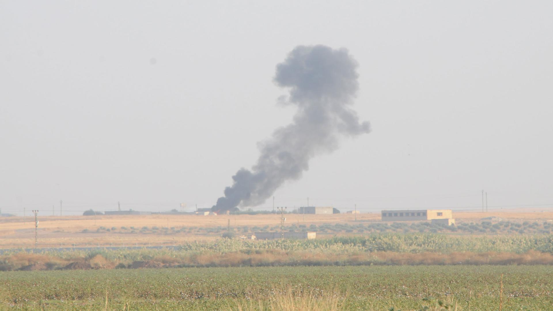 Smoke rises from the Syrian side of the border.
