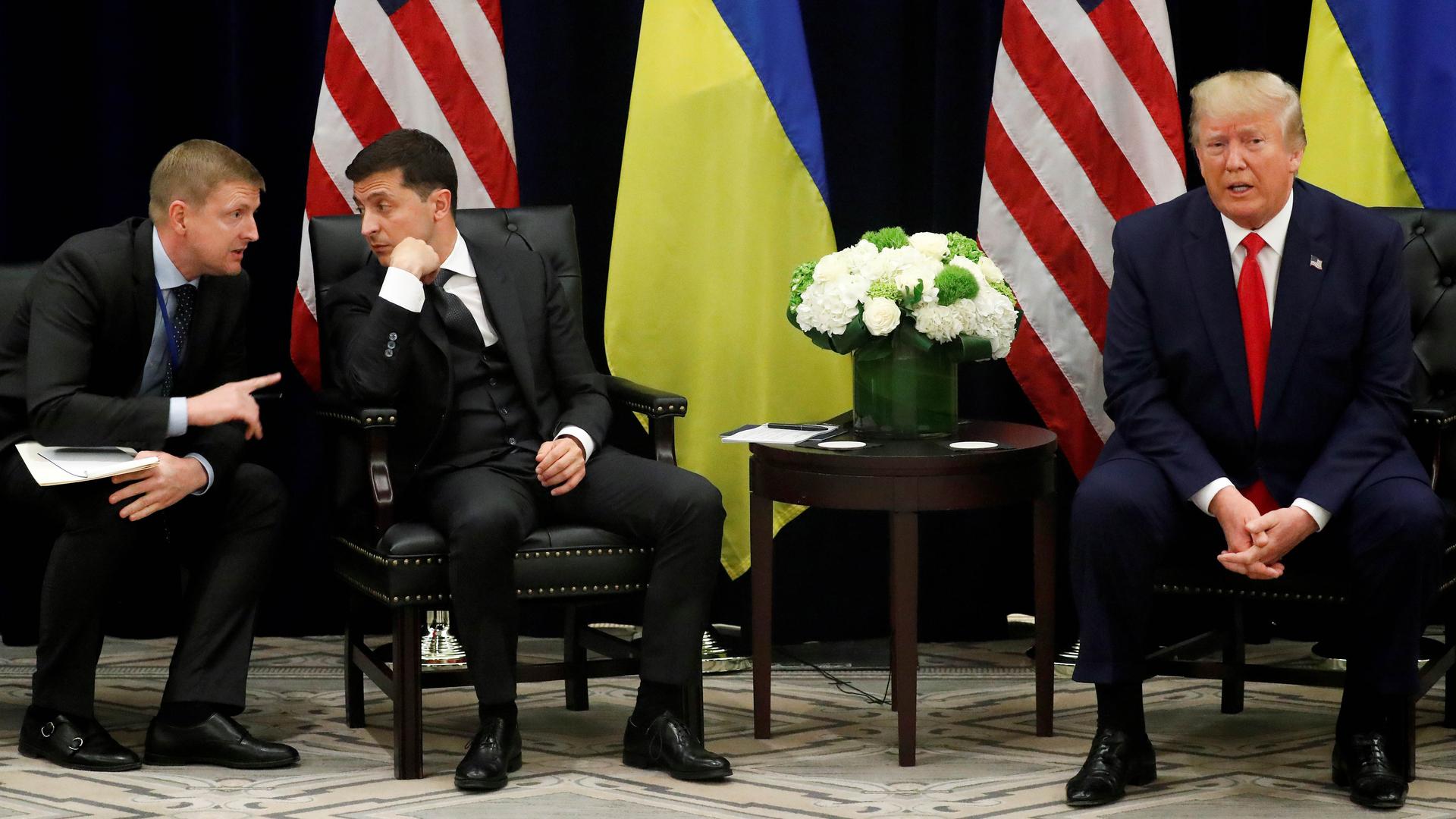 Ukraine's President Volodymyr Zelenskiy listens to a translator as he and US President Donald Trump hold a bilateral meeting