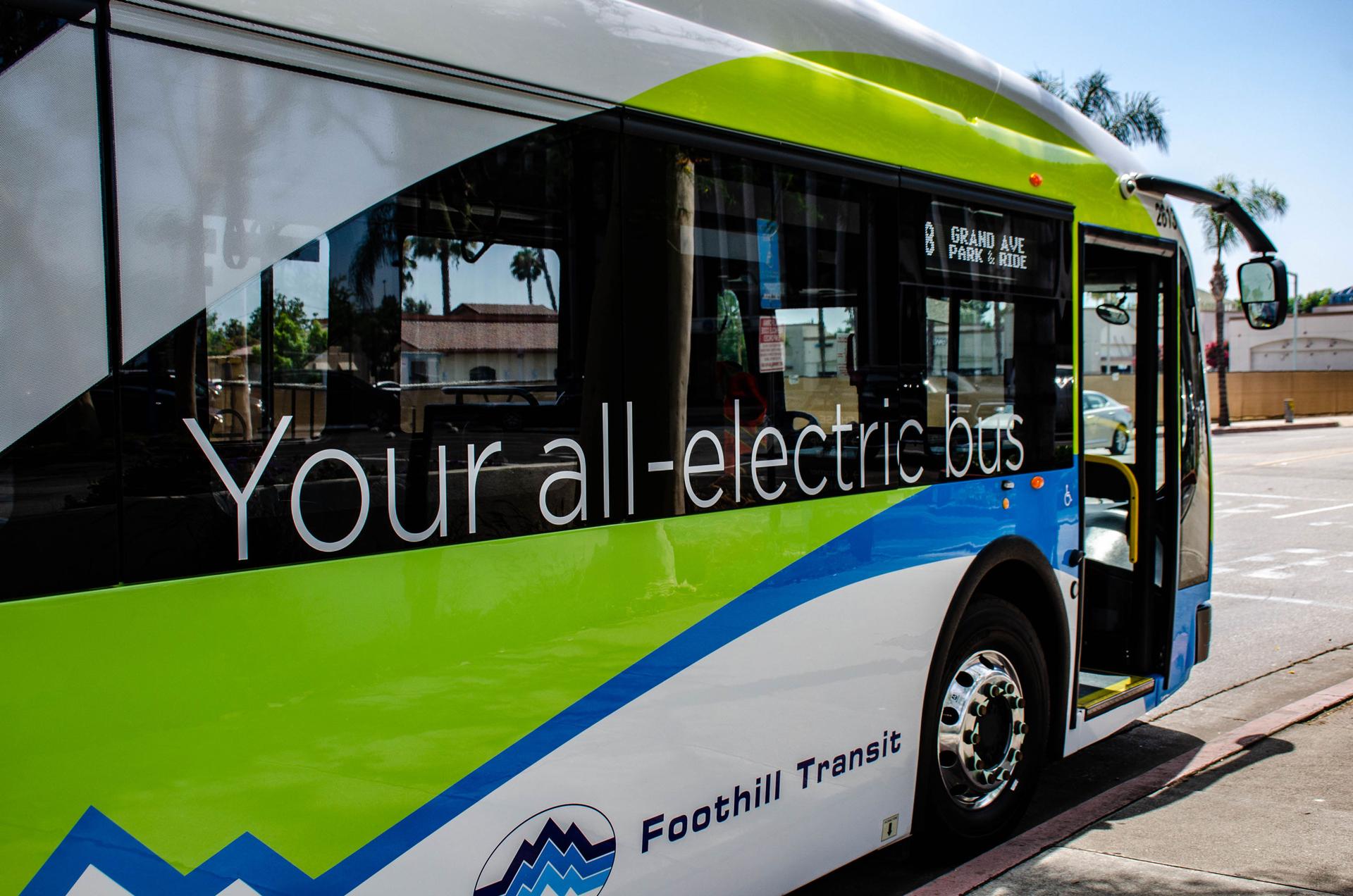 The side of an electric bus is shown with the words, 