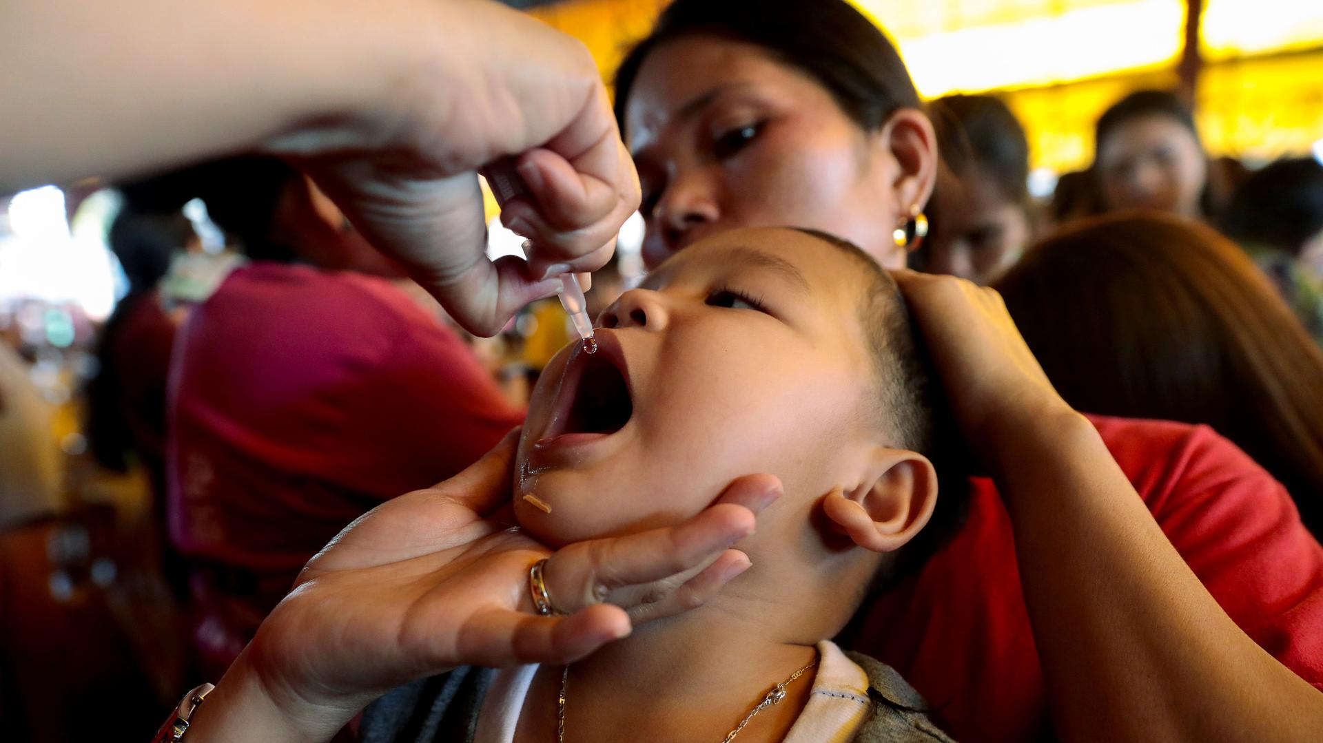 A child receives free polio vaccine during a government-led mass vaccination program in Quezon City, Metro Manila, Philippines, October 14, 2019. 